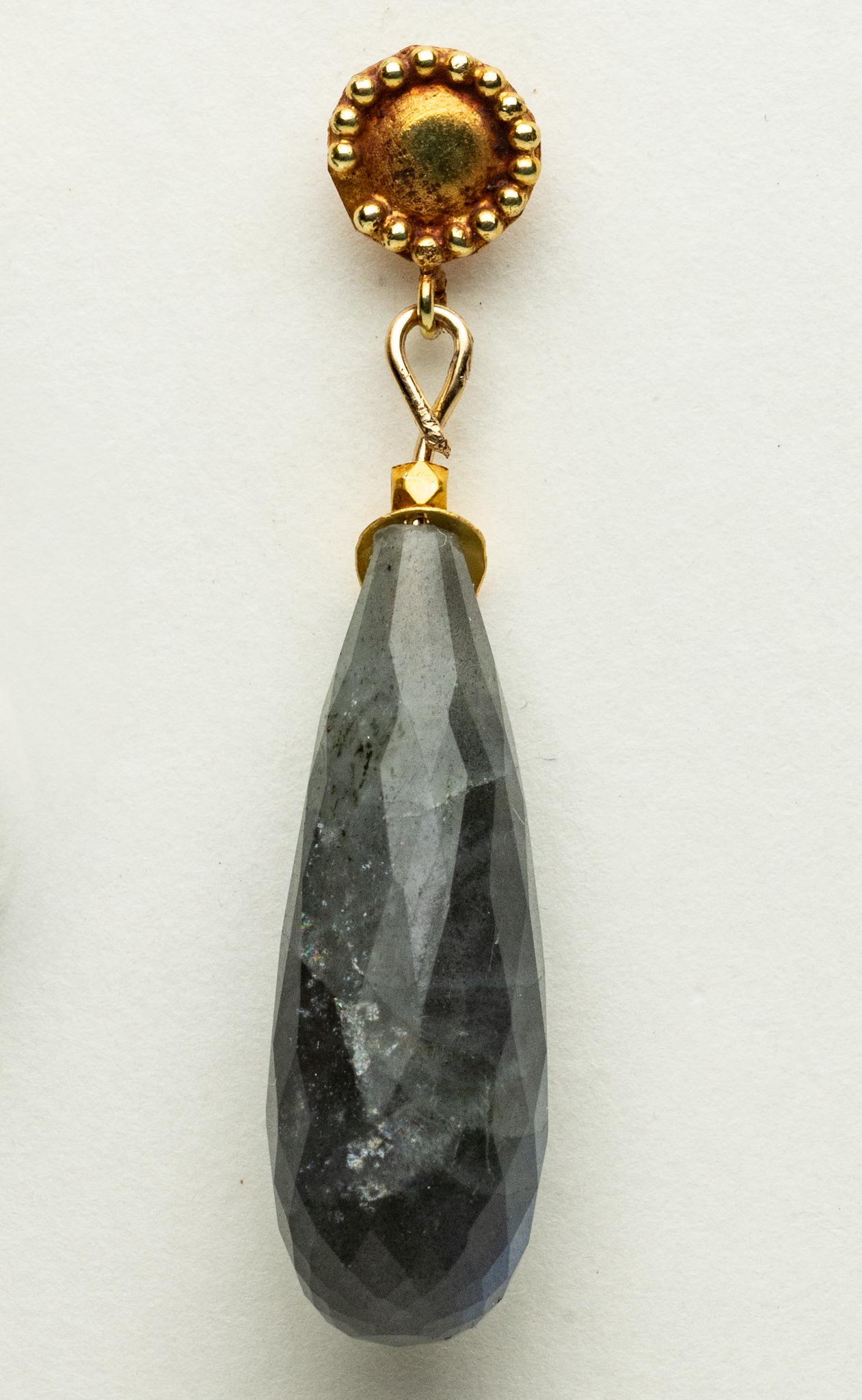 A lovely pair of faceted, long briolette labradorite drop earrings with an 18K gold leaf-motif over the top and 18K gold post for pierced ears.

The fine jewelry collection is sourced, designed or created by Deborah Lockhart Phillips. Through her