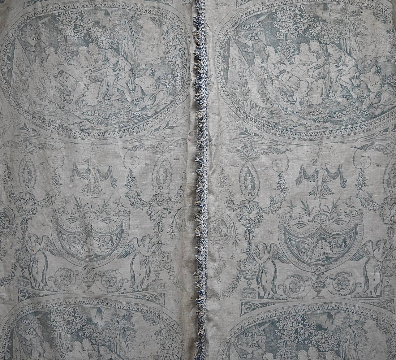 Later 19th century, French prettily faded blue toile pair of linen curtains. The design is a large-scale version of a circa 1790 Toile de Nantes called 'Telemaque et Calypso'. Home-made with an unfinished top and linen with a white linen. Edged with