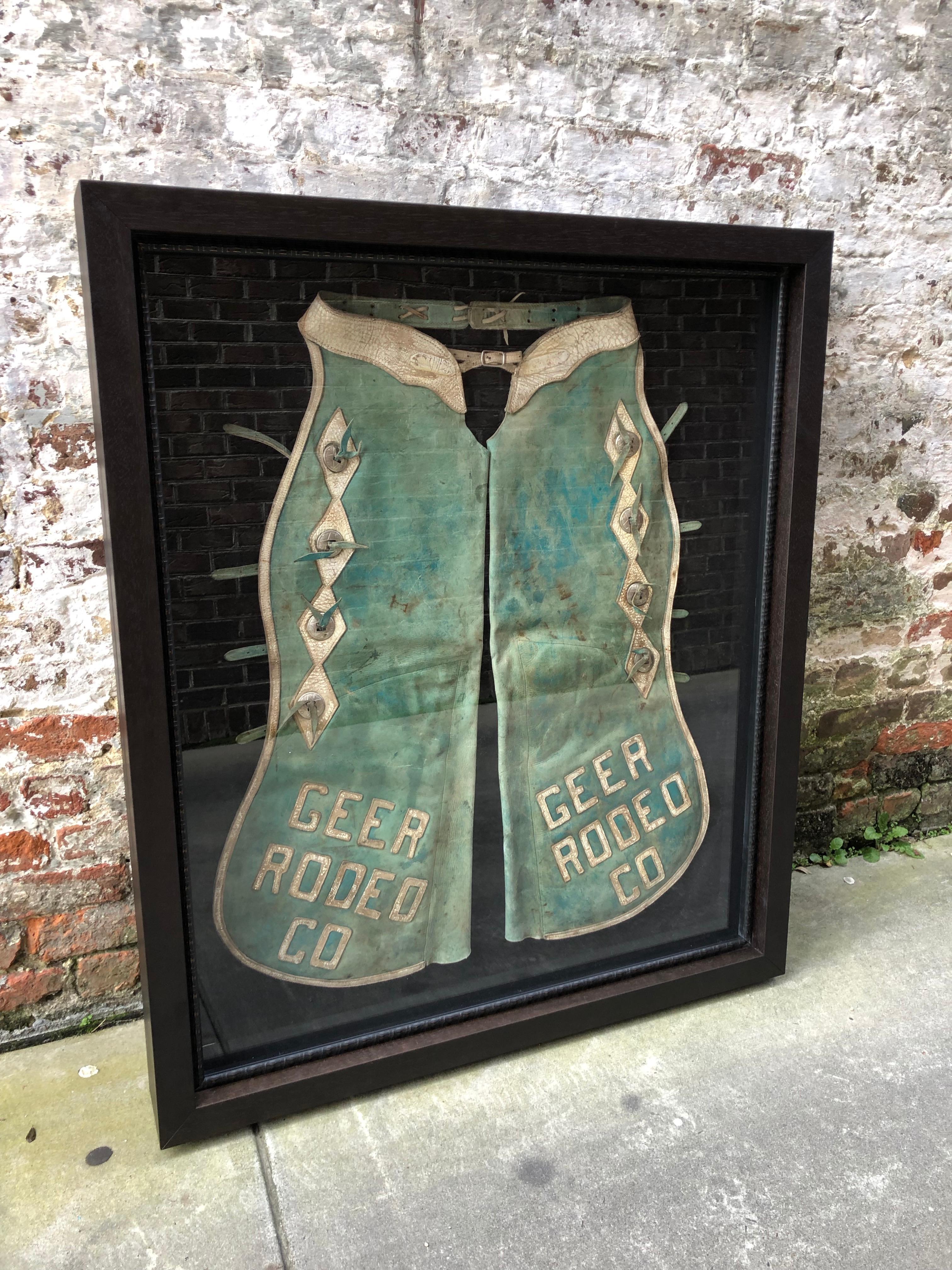 Pair of faded turquoise chaps with silver mounts with Geer Rodeo Company.
