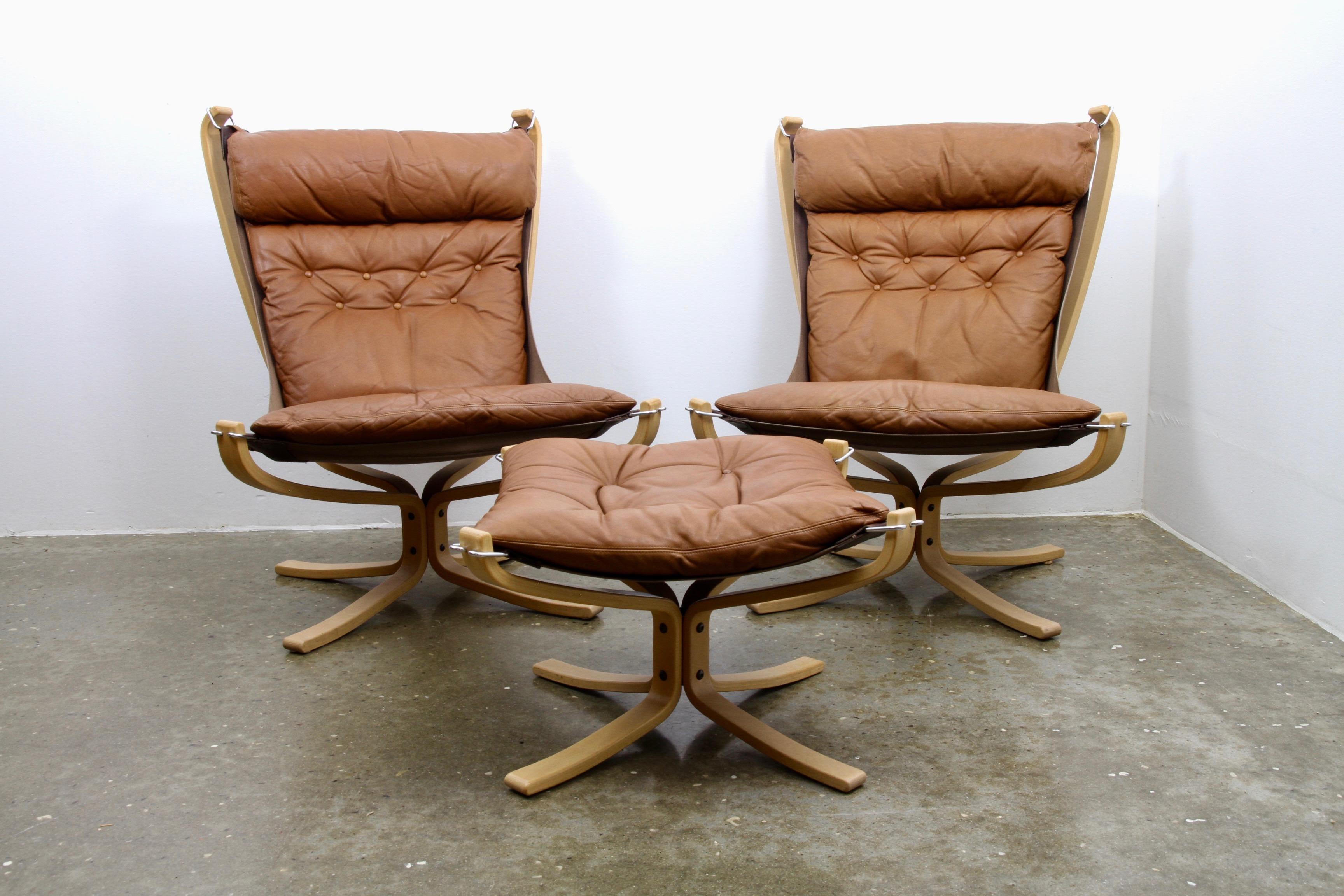 Pair of Scandinavian modern high back lounge chairs with beech frame and leather cushions. Seat is suspended from the frame for great comfort. Beautiful and soft light brown leather. Very light use, extremely good vintage condition. Designed by