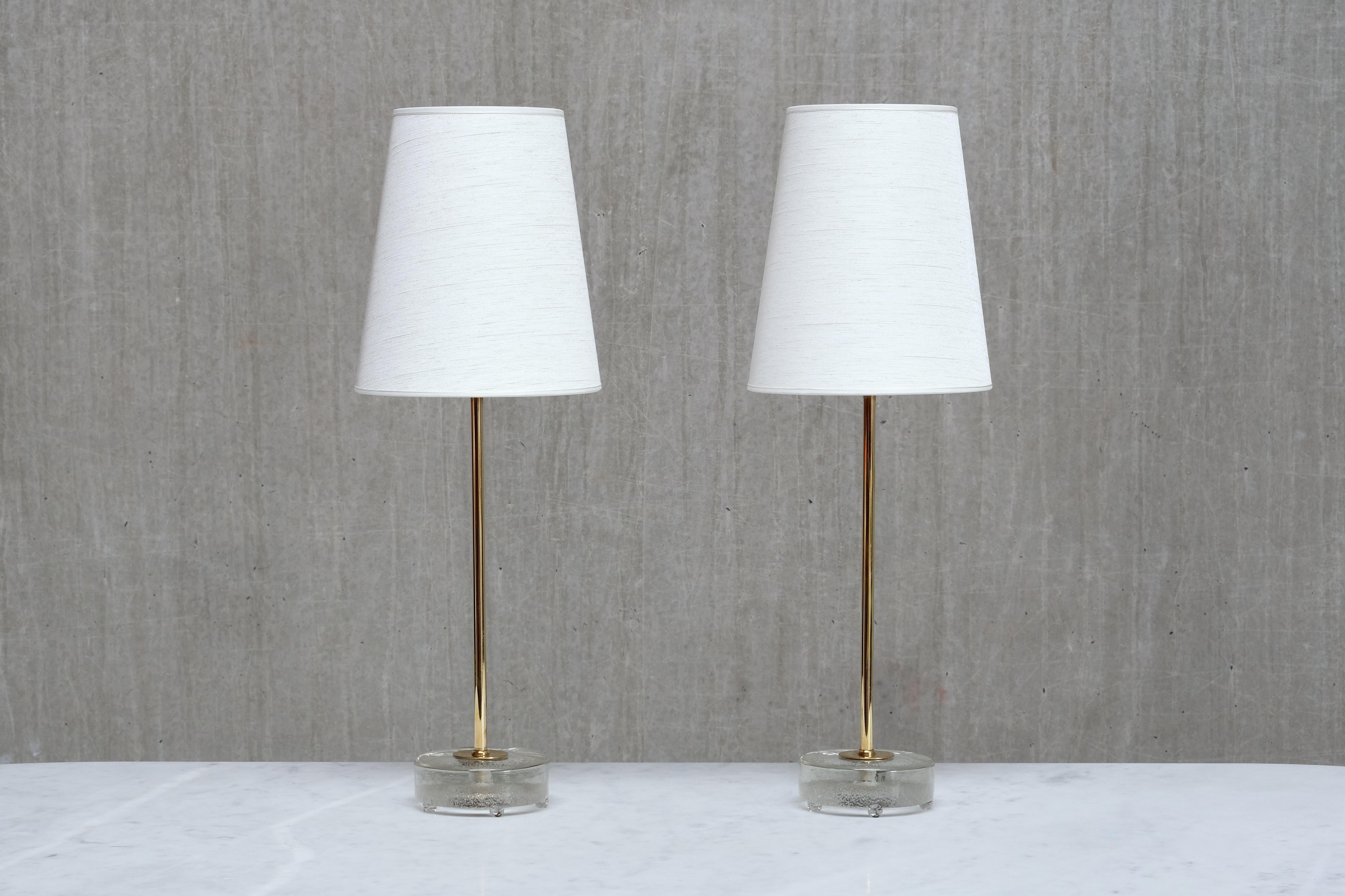 This elegant pair of table lamps was produced by Falkenbergs Belysning in Sweden in the 1960s. The lamps are signed with the manufacturers initials FLB on the bottom of the base.

The design is composed of a slightly raised, circular foot in