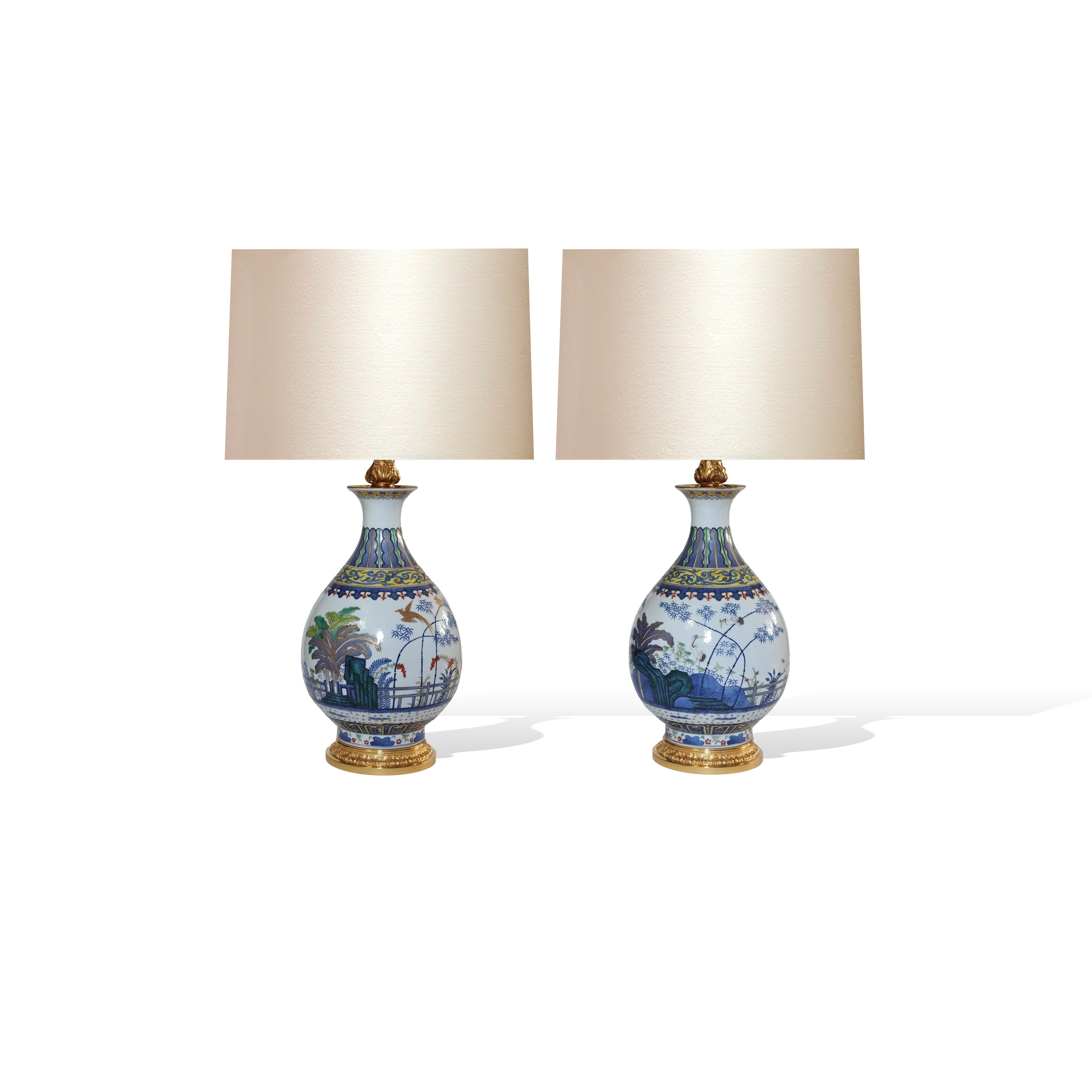 Pair of Famille Rose porcelain lamps with cranes in the garden decoration.
To the top of the lamp body: 14”/H. 
(Lampshades not included).