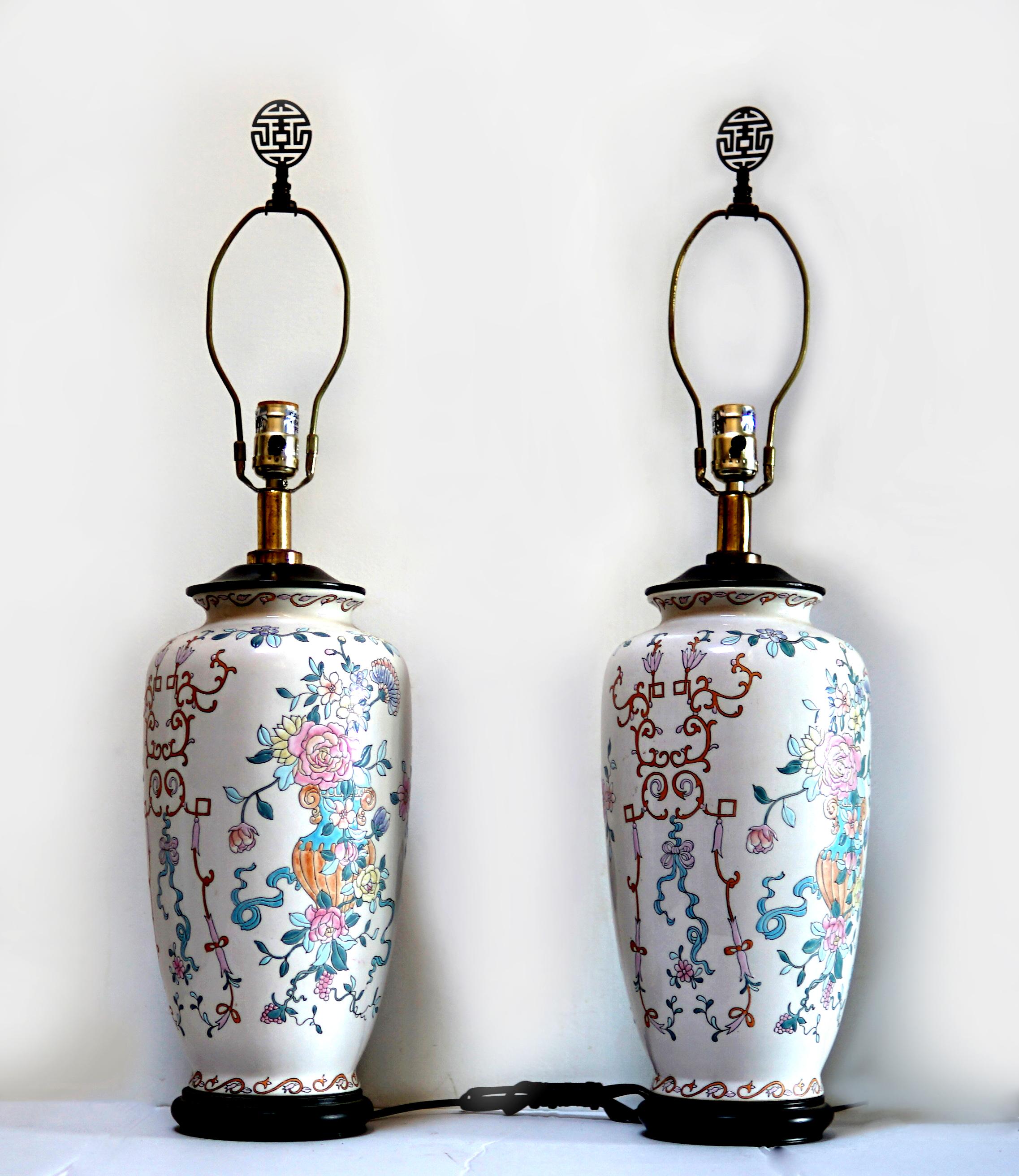 A soft color palette on a blush-colored ground Famille Rose table lamp creates statement lighting. The overall pattern, porcelain quality and the colors of the pair are entirely Hand Painted in a Famille Rose Pattern.  This pair of Chinese Porcelain