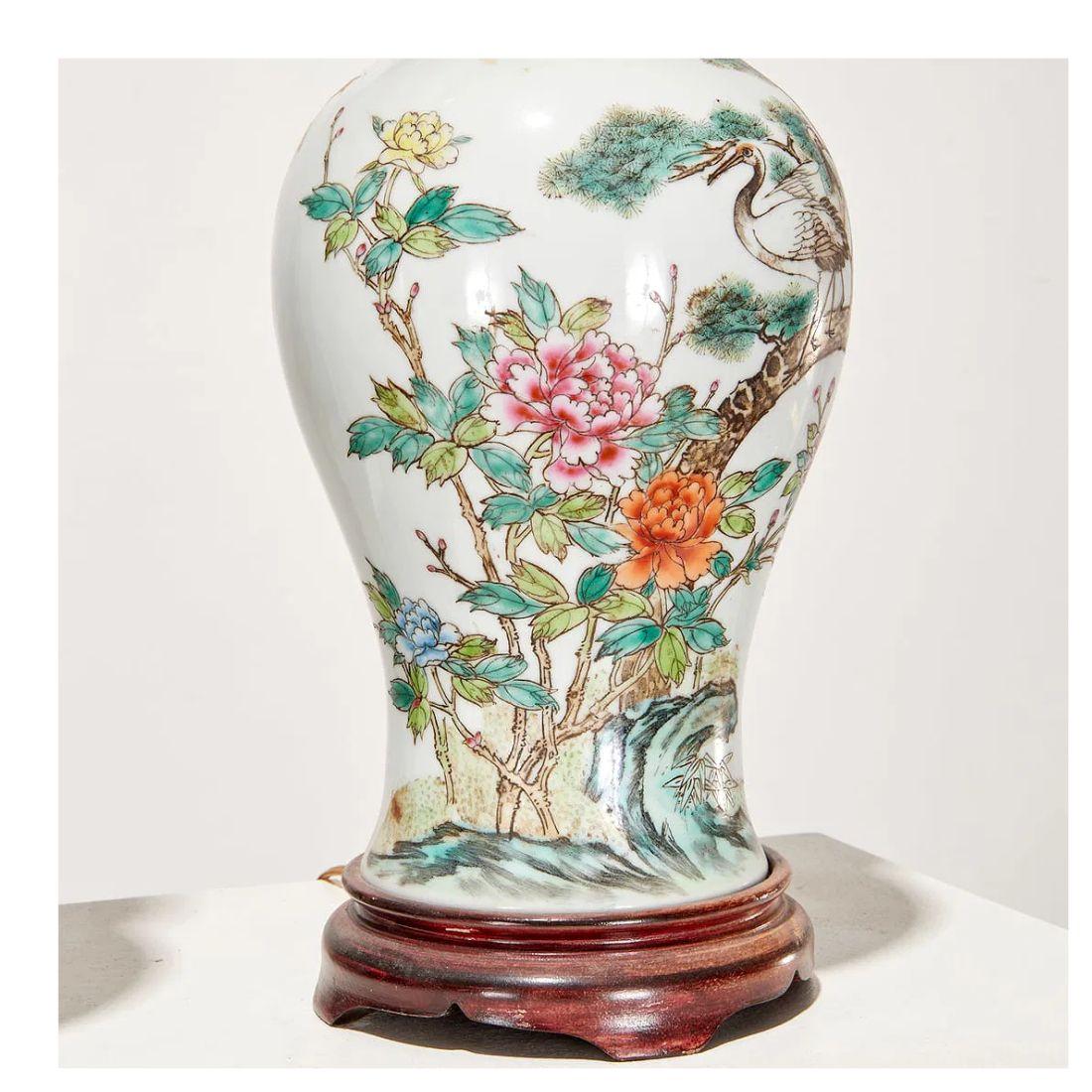 A beautiful pair of Chinese Famille Verte porcelain vases, now mounted as elegant table lamps. Each baluster-form vase is richly decorated in polychrome enamels, featuring exotic birds perched among flowering branches—an enduring motif symbolizing