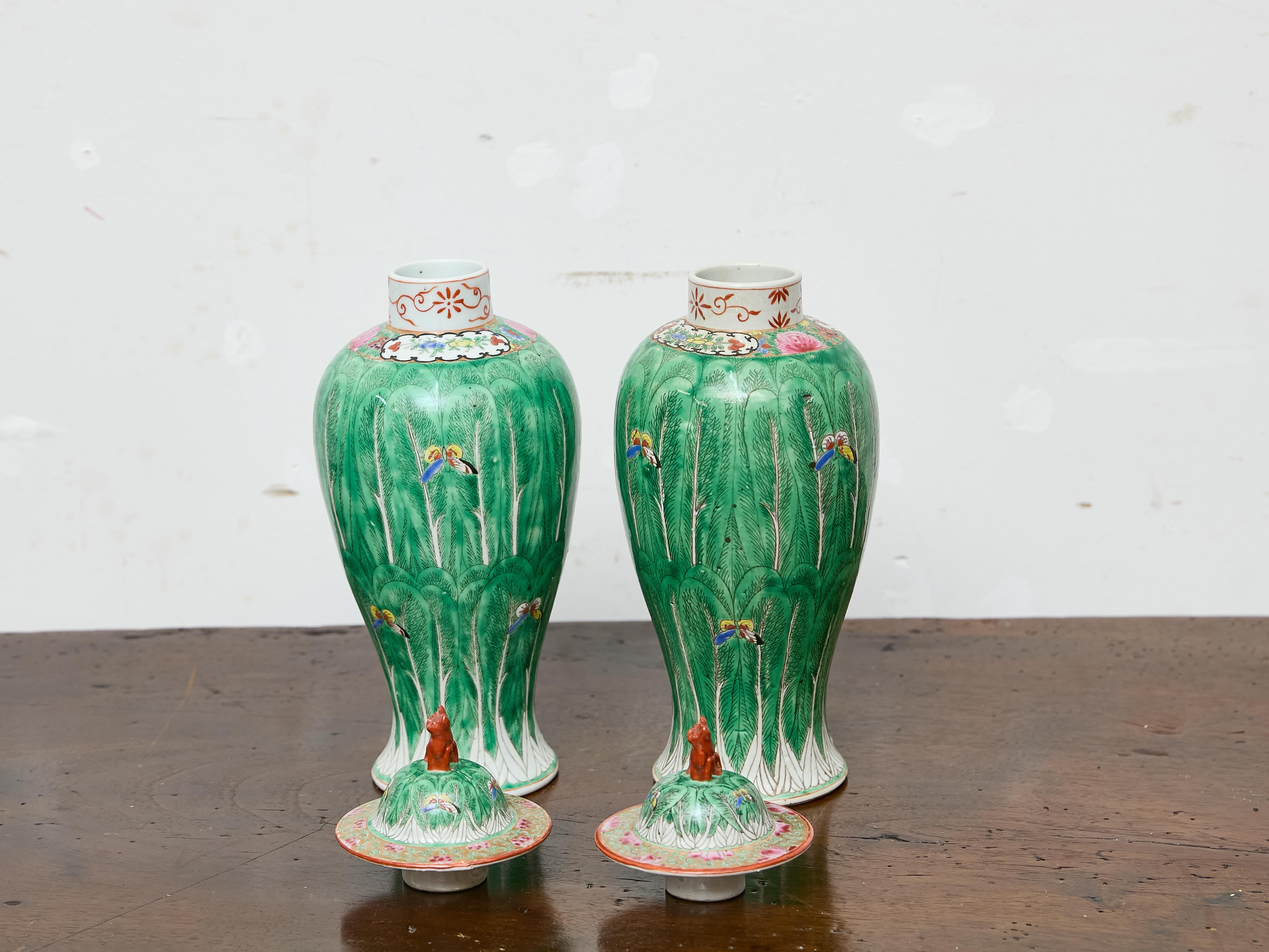 Chinese Pair of Famille Verte Lidded Vases with Butterflies and Lion Finials, circa 1920 For Sale