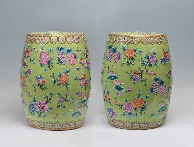 Green-ground porcelain stools with finely carved low relief flower blossom decoration.
