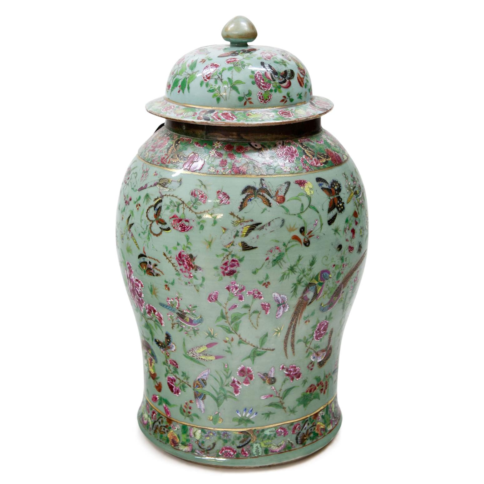 Pair of famille verte lidded urns with iron fittings and hinges as well as a polychrome paint in the shape of flowers, birds and butterflies.