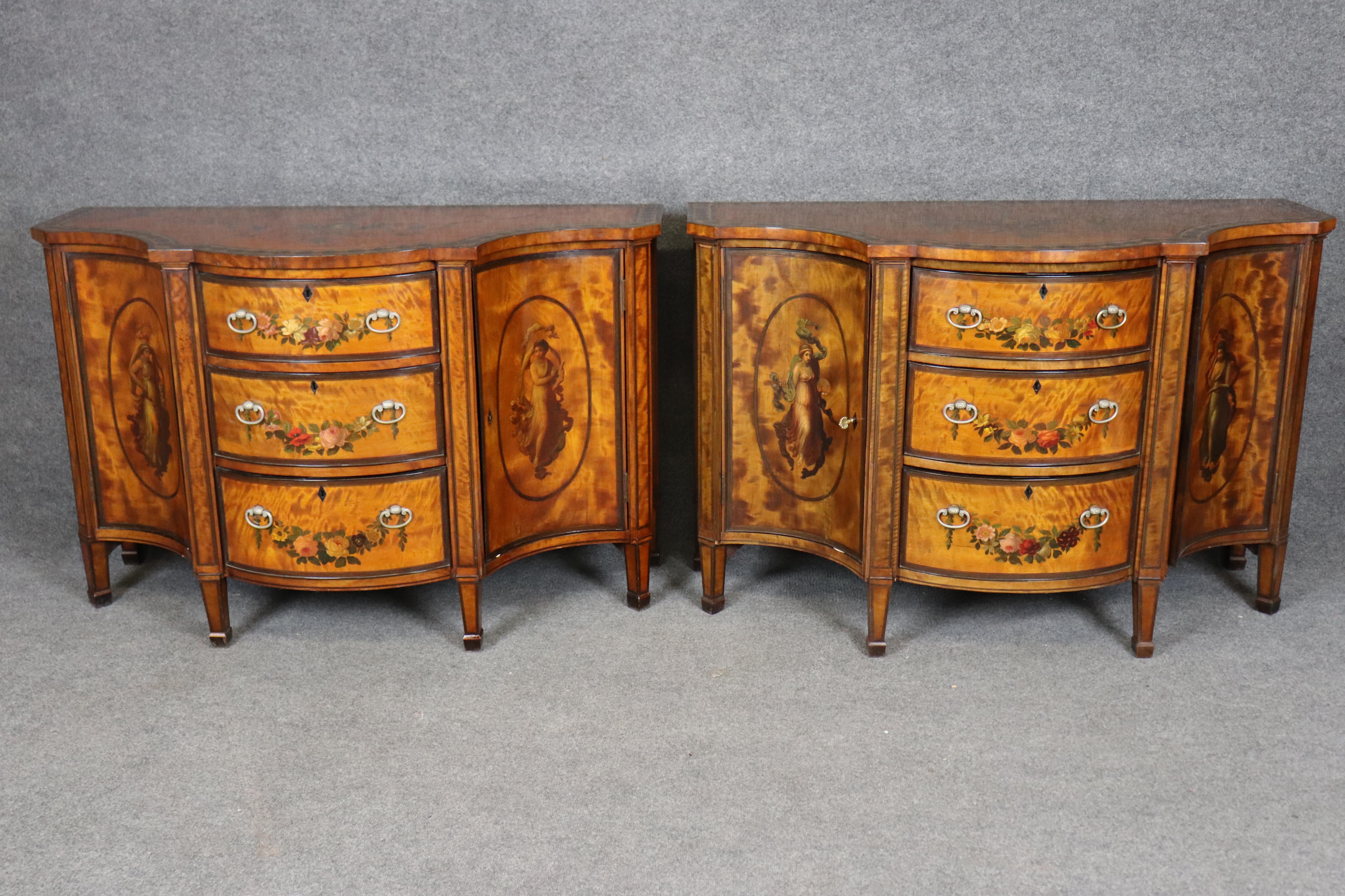 This magnificent pair of late 19th-century English commodes exemplifies the refined elegance and neoclassical artistry associated with the Adams style. Crafted circa 1890, each commode showcases richly figured satinwood veneers of exceptional depth