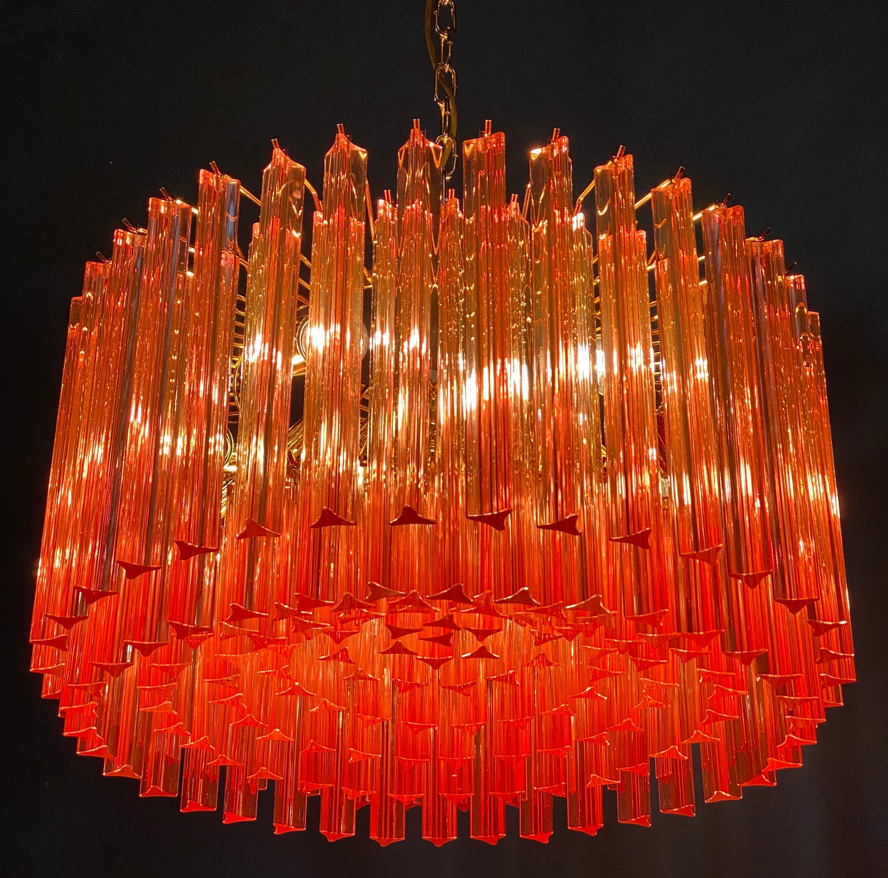 Fabulous Murano glass chandelier with stunning coral color triedri on brass frame.
Available a pair and a pair of sconces .

Dimensions: 43.30 inches (110 cm) height with chain; 13 inches (33 cm) height without chain; 23.5 inches (60 cm)