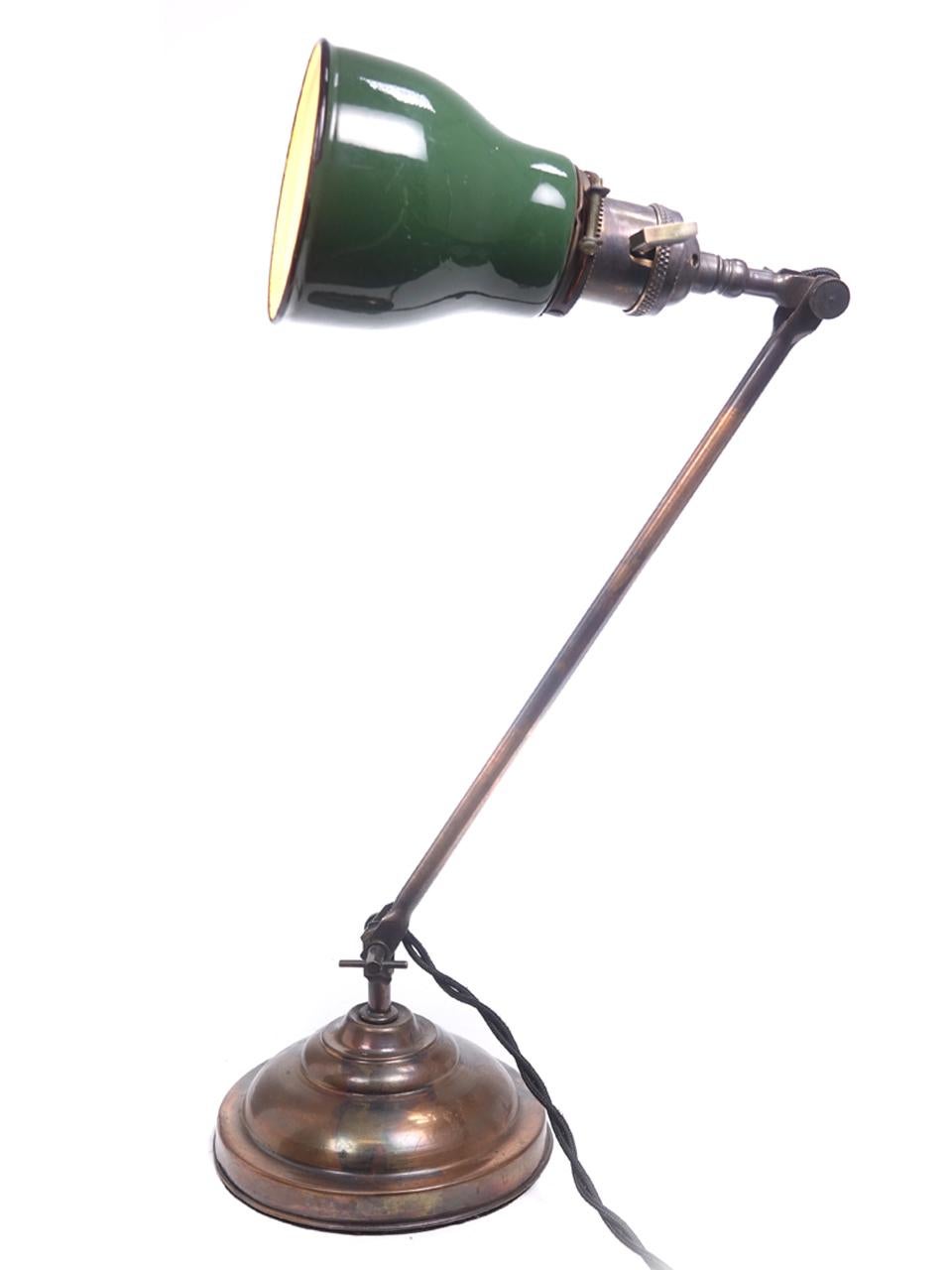 This is a beautiful matching pair of Industrial lamps by the Faires Lighting Company. Both have the original Japanned copper or black finish and mini green over white porcelain coated shades.