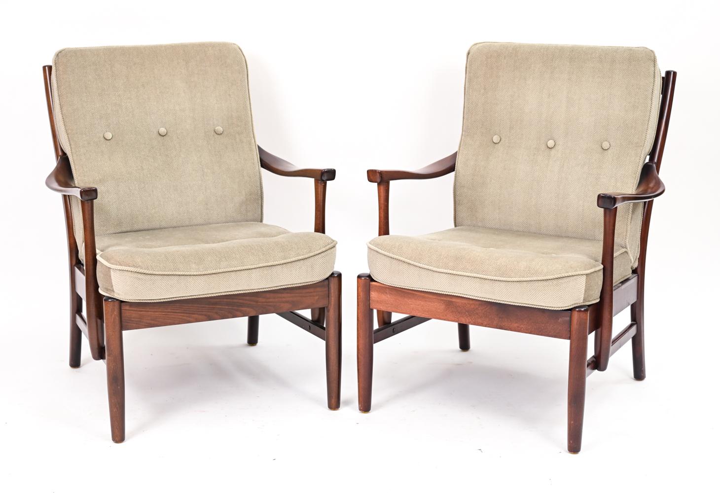 An elegant pair of Scandinavian modern fauteuil lounge chairs by Danish manufacturer Farstrup, boasting quality craftsmanship and design. These Casa easy chairs have sturdy sculptural frames in handsome stained beech wood with curvilinear open