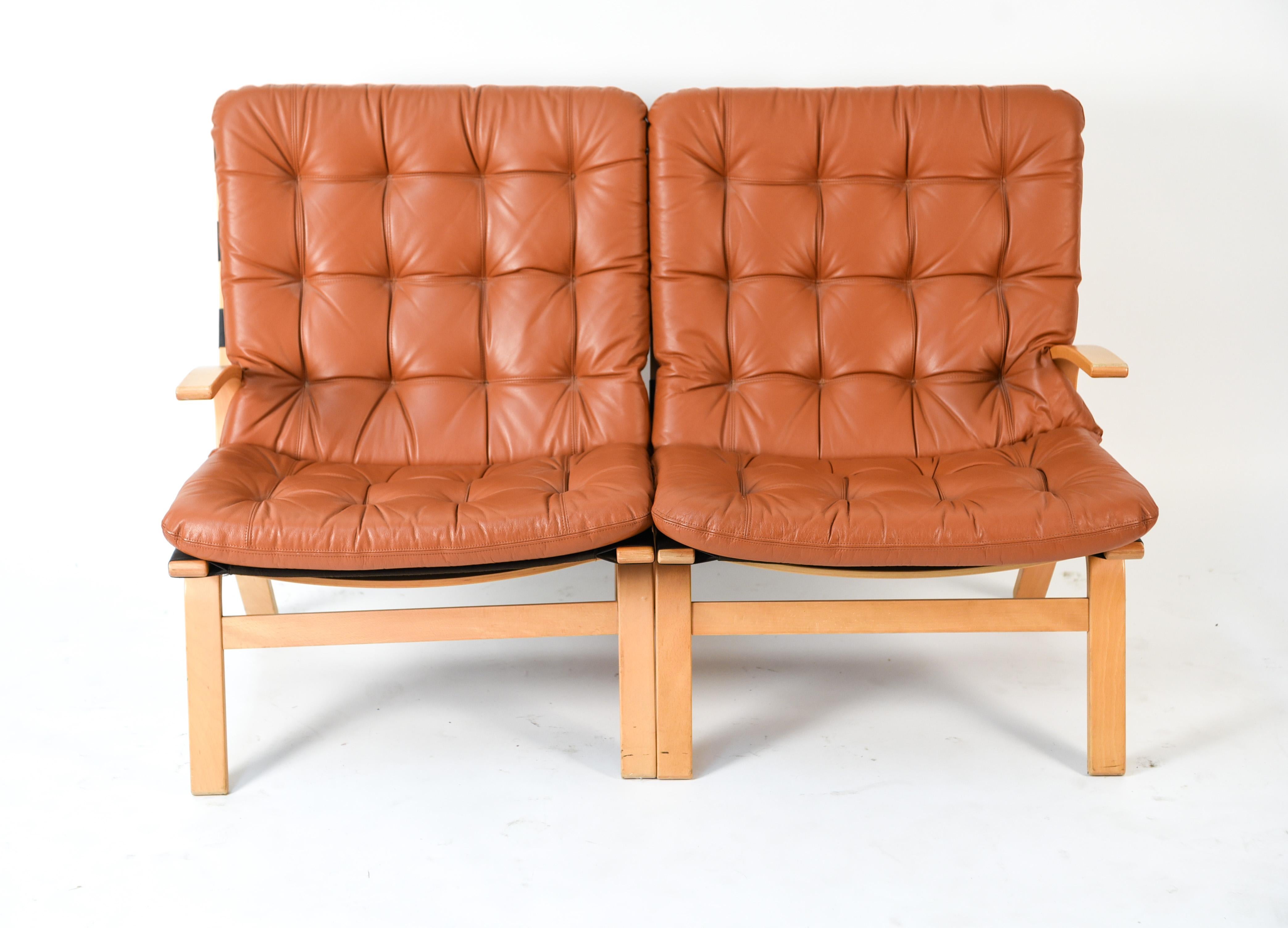 This Danish midcentury bentwood loveseat was made by Farstrup, circa 1970s. This two-seat sofa features tufted cushions which provide an element of texture juxtaposed against the smooth bentwood frame.