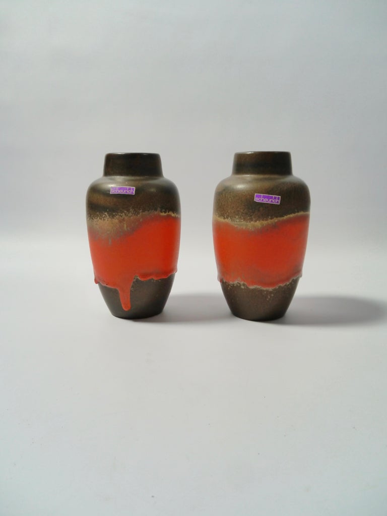 A pair of fat lava ceramic vases made by Scheurich, West Germany, 1960s. Very similar to each other in glazing and color. Both with original sticker.