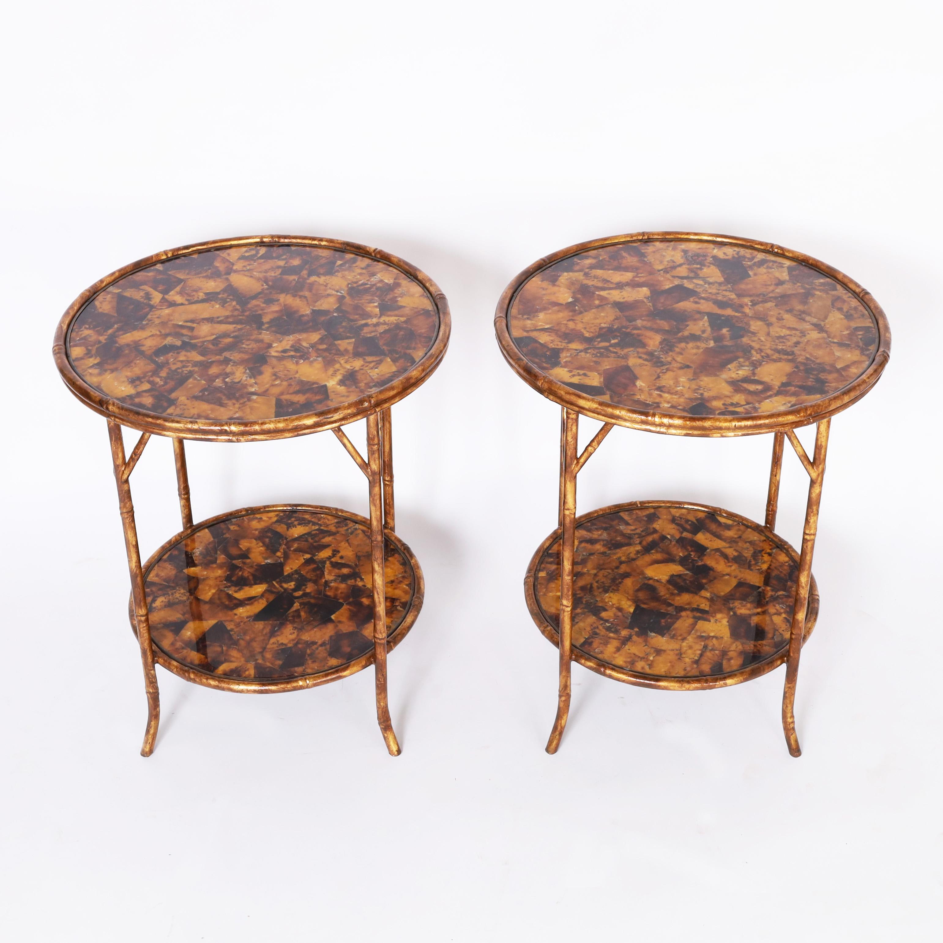 Impressive pair of mid century stands with faux bamboo metal frames having Asian style brackets and splayed feet, featuring two tiers of tessellated penshell.