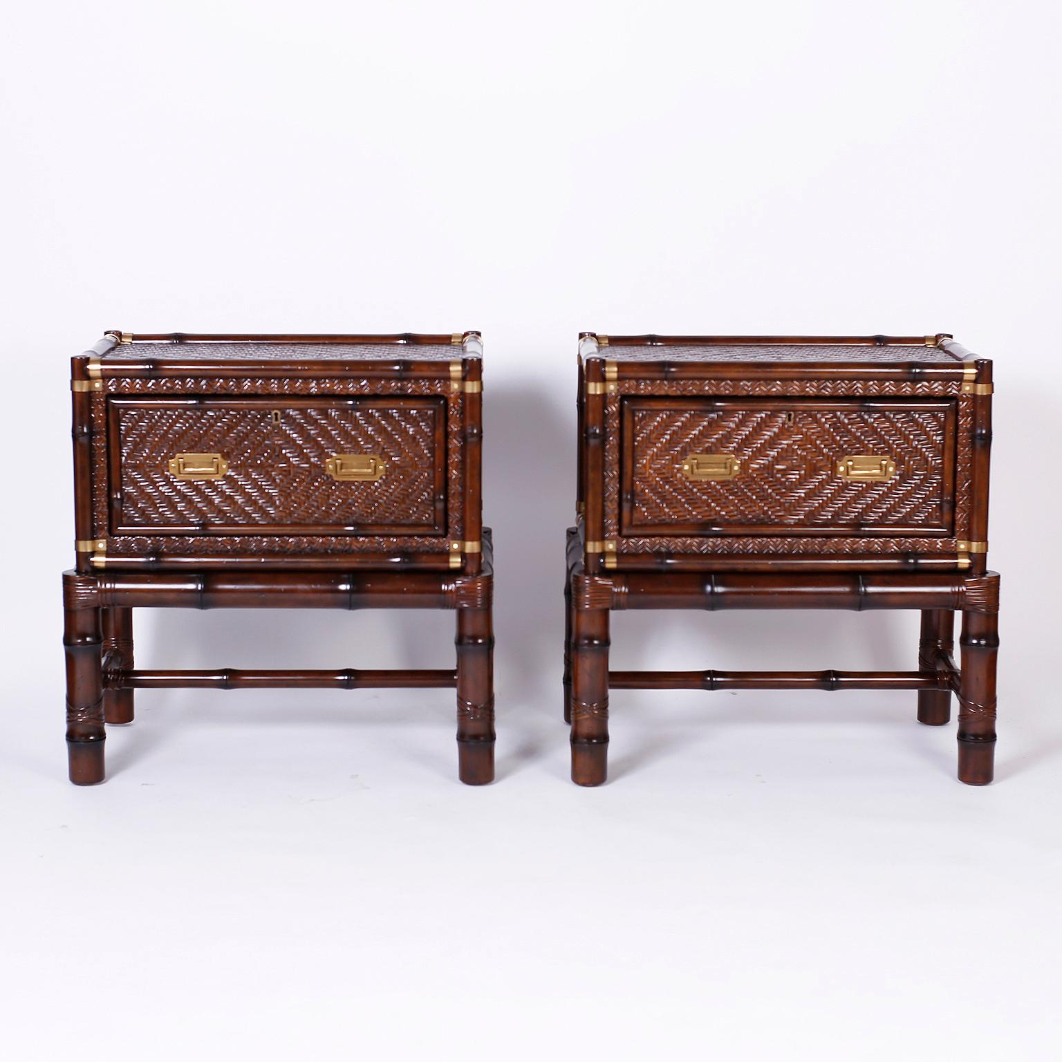 Pair of campaign style one drawer chests on stands or tables with faux bamboo frames, herringbone rattan panels, and brass campaign style hardware. Signed Ralph Lauren in a drawer.
