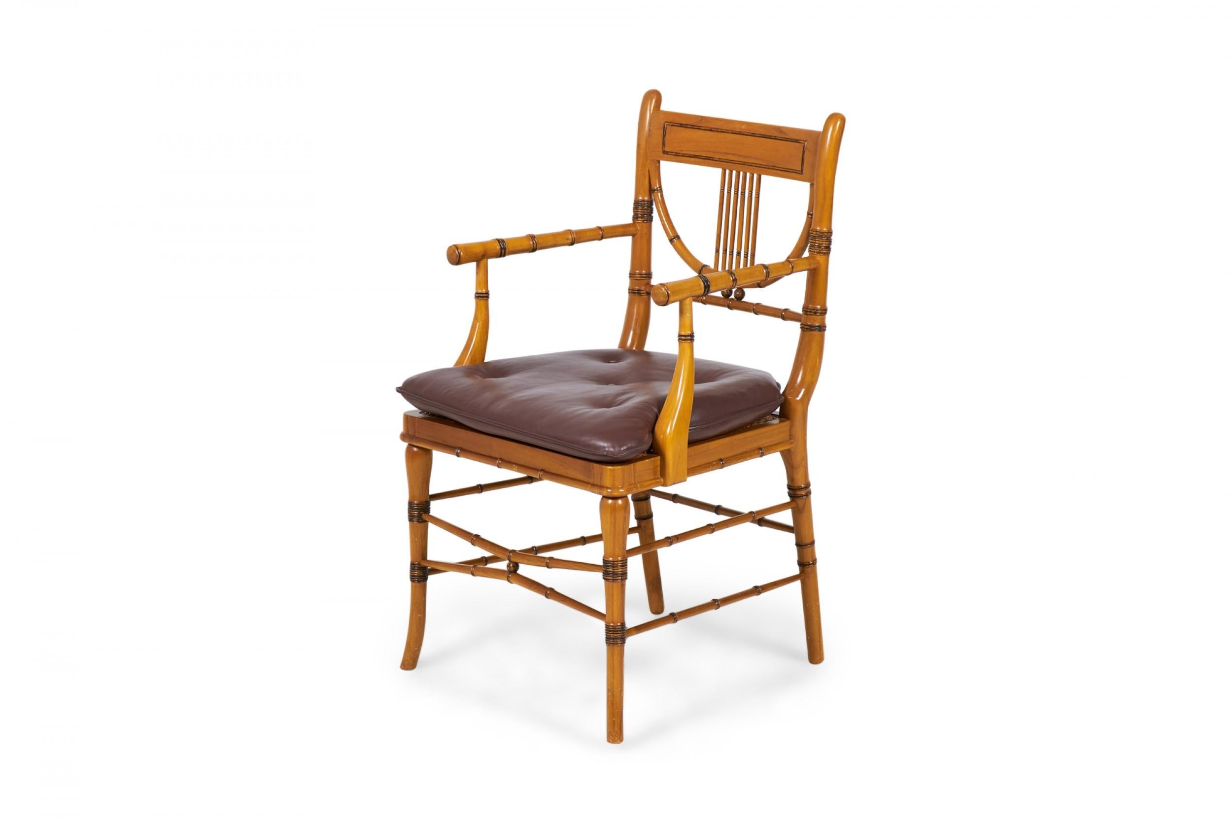 Pair of English Regency style (late 20th century) faux bamboo armchairs with turned maple frames comprised of a rectangular back rail connected by vertical slats to a semi-circular back piece and a box stretcher base with taupe brown button tufted