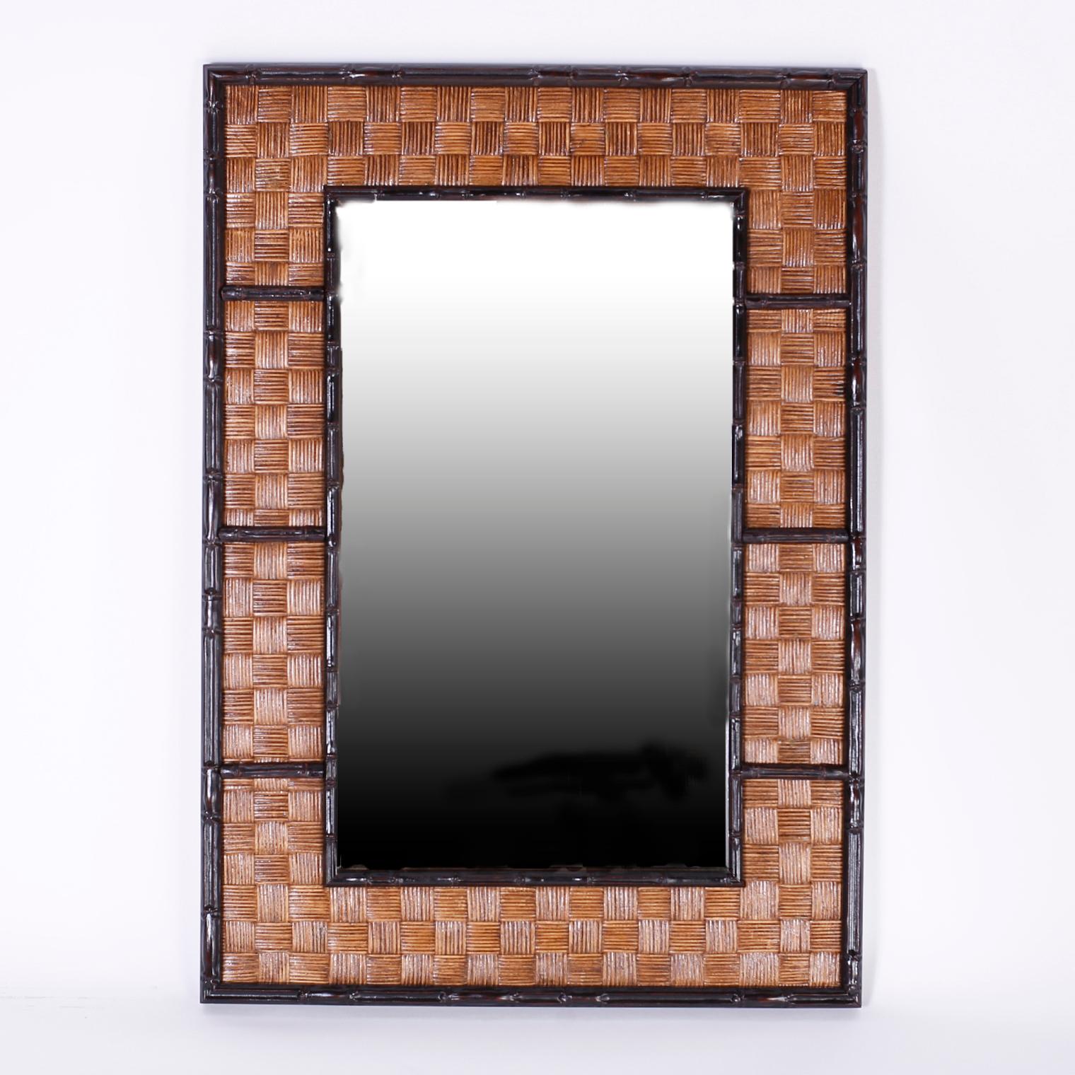 Pair of midcentury rectangular mirrors with ebonized carved wood faux bamboo borders around patch work braided reed, giving this pair a warm, earthy yet hip and modern vibe.