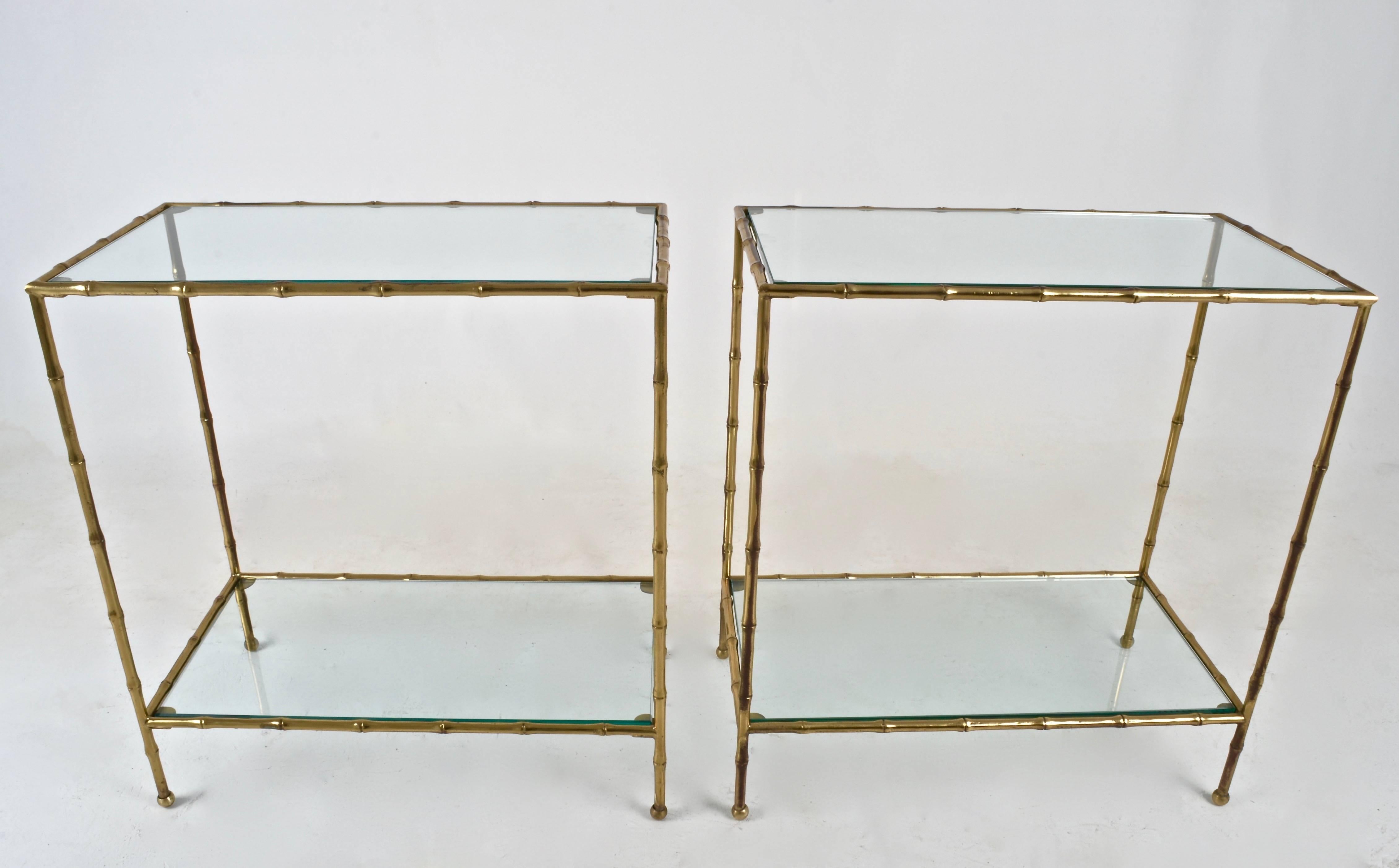 A very nice quality pair of side tables. Solid Bras with heavy glass tops and lower shelf. Small ball feet. Original brass finish has some patina for antique look. Brass may be polished and lacquered.