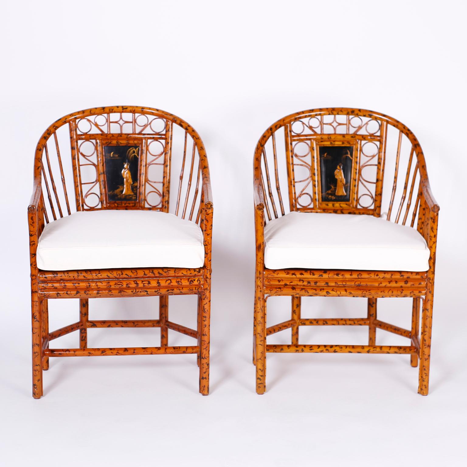 Handmade pair of Brighton Pavilion chairs with classic form featuring a faux burnt bamboo finish, caned seats, and lacquer panels with chinoiserie figures. Signed Maitland-Smith on the bottoms. 

Seat height without cushion is 18