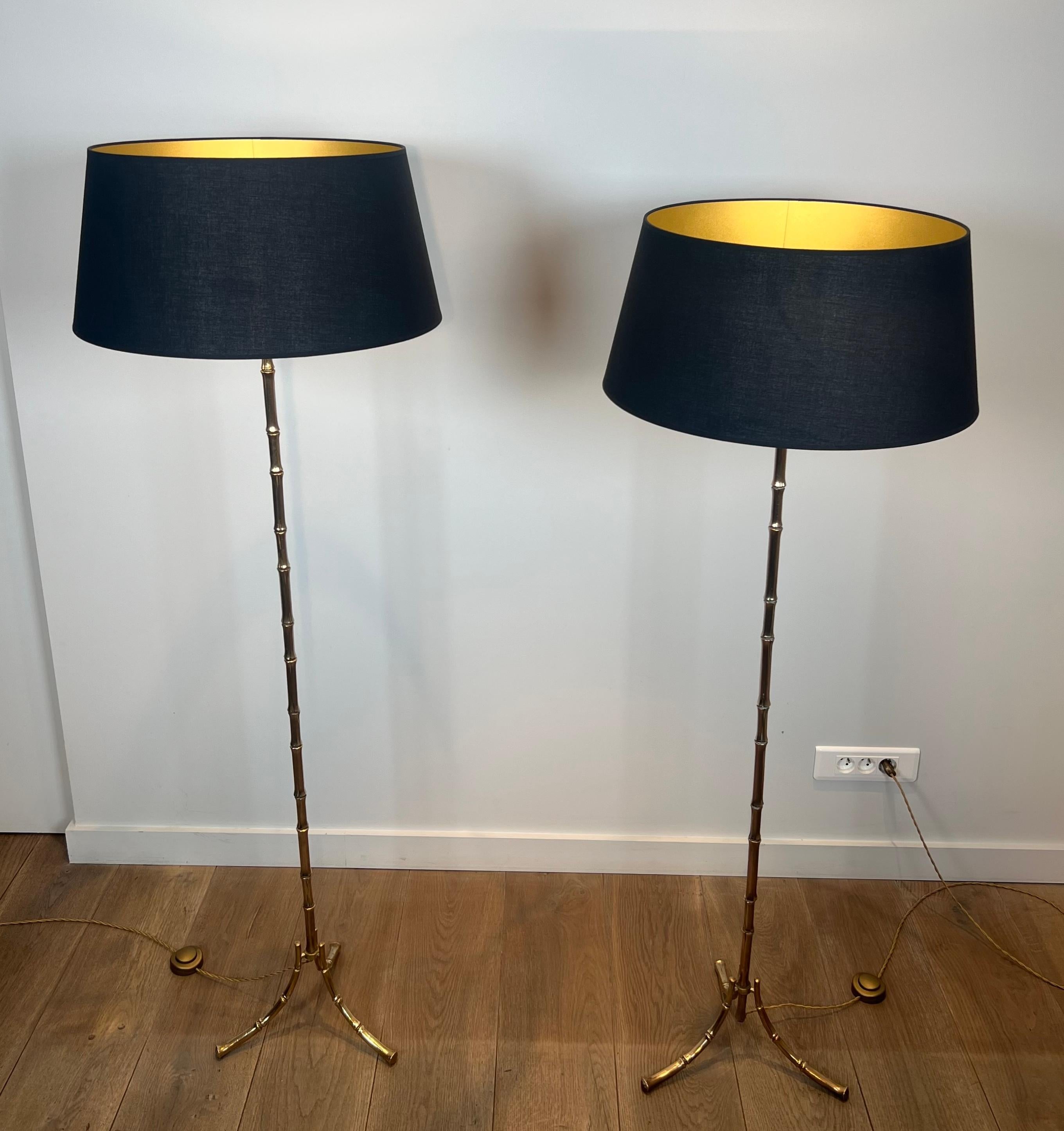 This rare and very nice pair of faux-bamboo floor lamps is made of bronze. This is a French work by Maison Bagués. Circa 1940 (False pair)