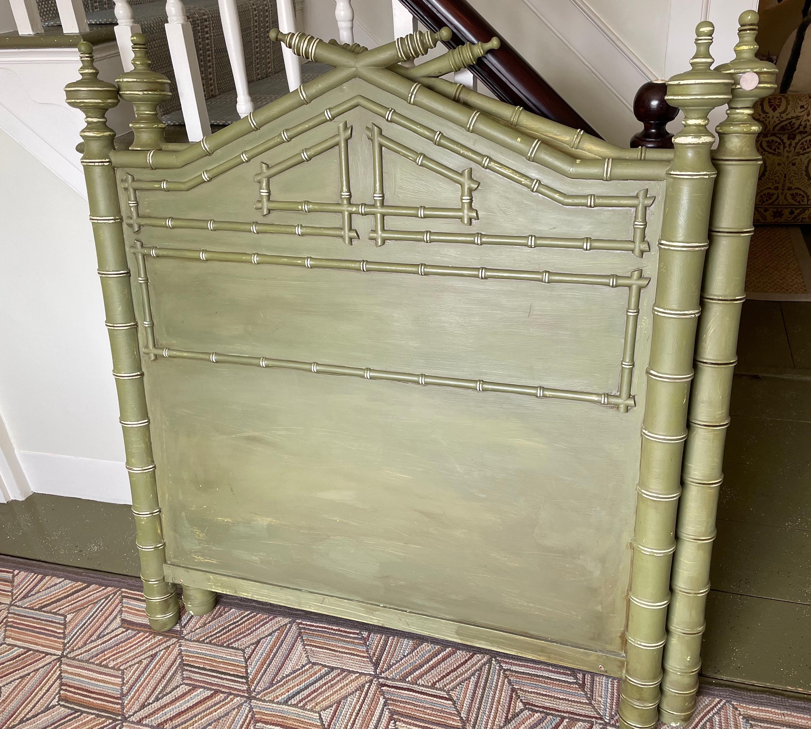 Pair of twin wooden headboards, with carved/incised faux bamboo details and allover green paint wash. Width between columns at base measures 39.5 inches wide. Intended to be positioned against walls, reverse sides painted but not finished (as noted