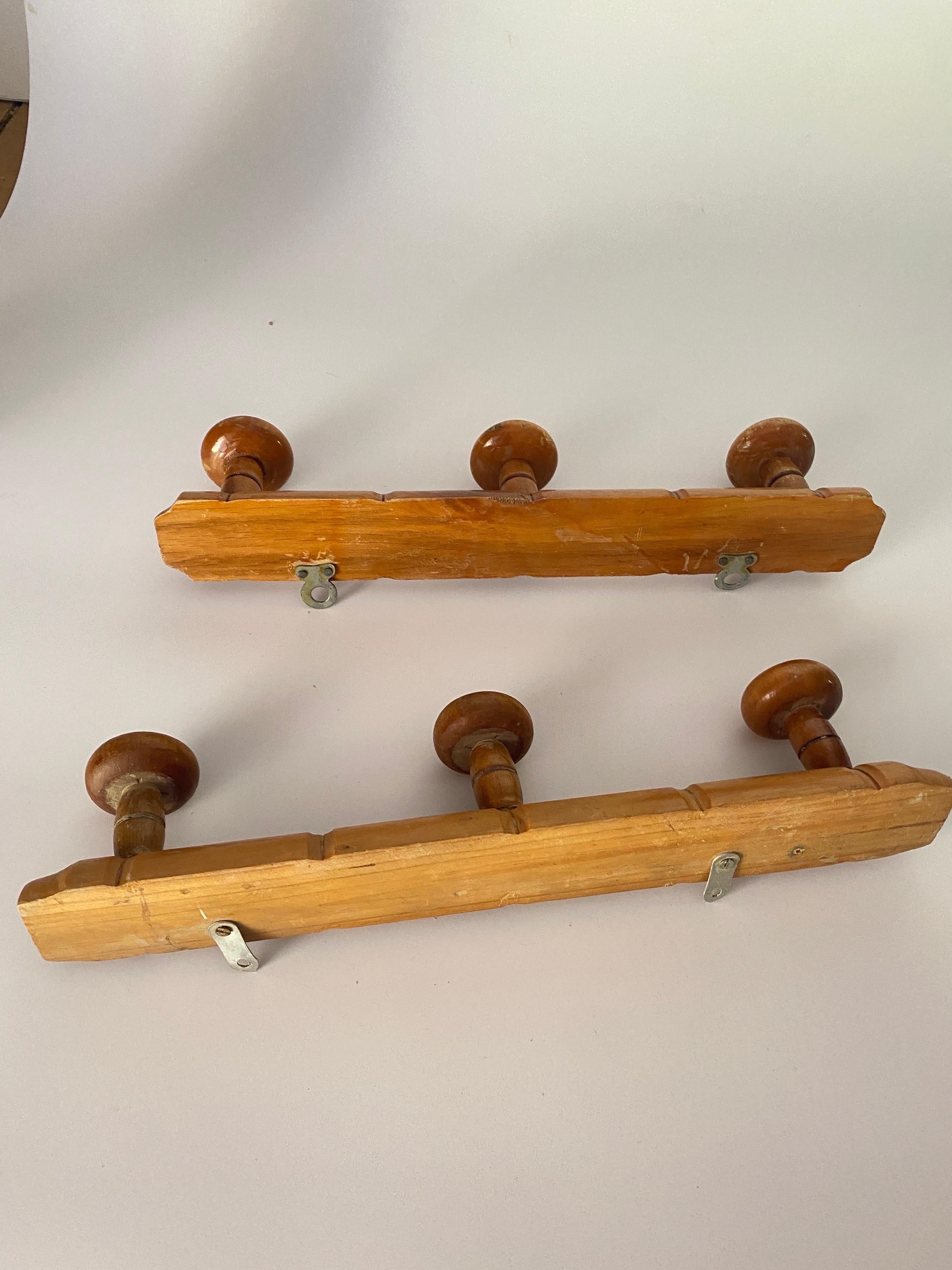 An early 20th century French maple pair of coat or hat rack, carved to mimic bamboo. Perfect for having hats, coats, belts, and scarves, or brooms and dustpans in our utility closet.
 