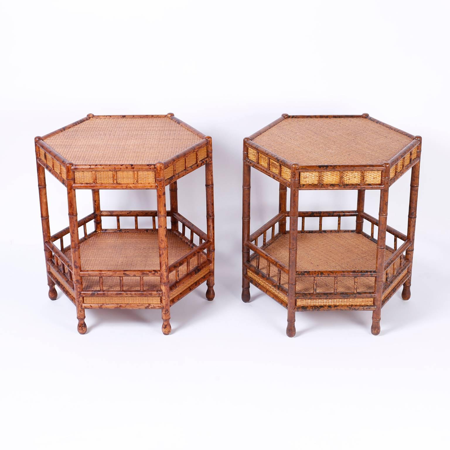 Handsome pair of two-tiered end tables or night stands crafted with turned wood faux bamboo or rattan and wicker or grasscloth that are an example of modern and traditional influences successfully combined.