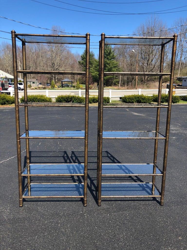 Pair of faux bamboo étagères. Solid, well made pair. Oiled tortoise shell finish. Perfect for storage of books and or decorative collectibles. In excellent condition. Each etagere has six glass shelves. The space between the glass shelves is as