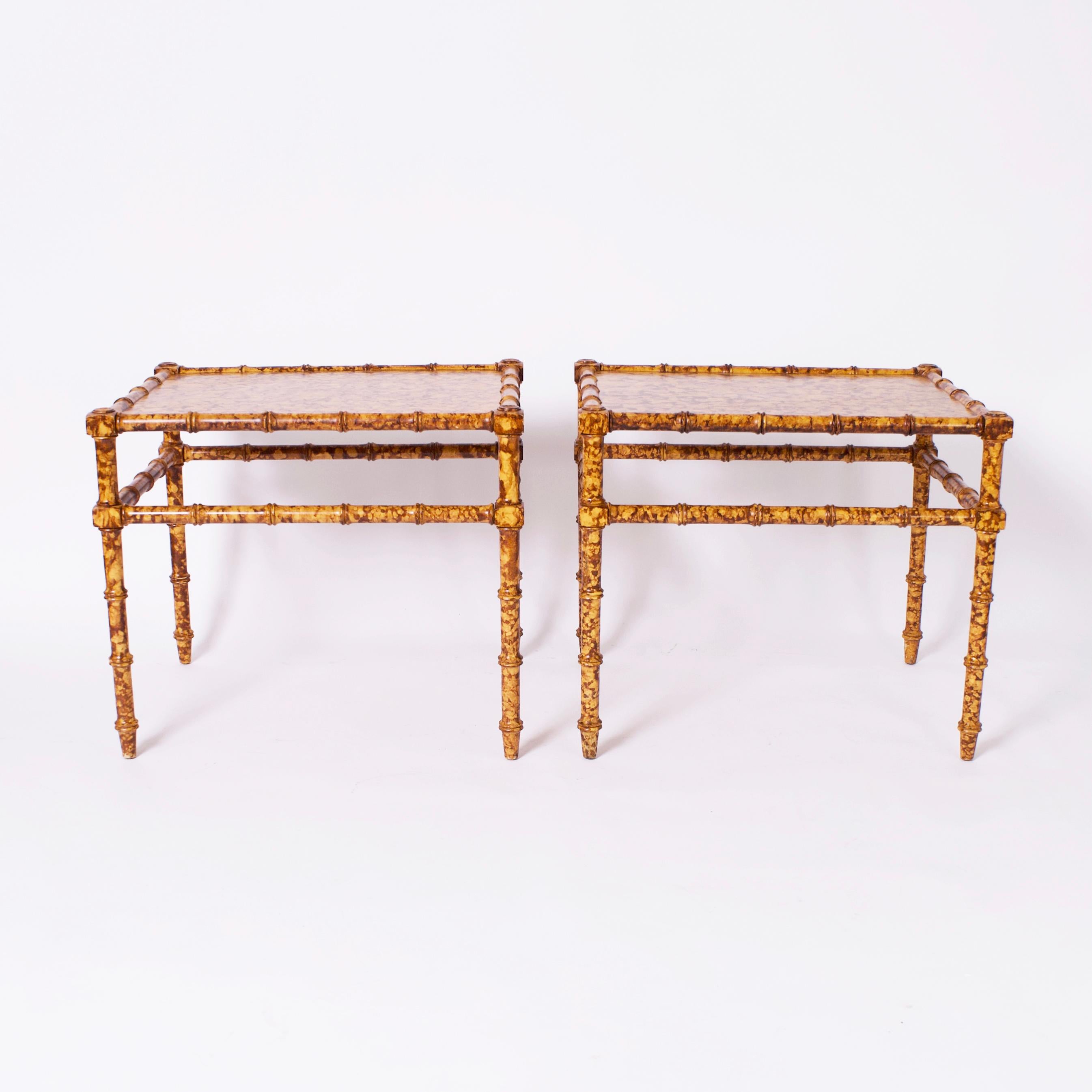 Standout pair of mid century stands crafted in hardwoods in a classic form having rectangular tops on faux bamboo bases and featuring a striking stylized faux tortoise finish throughout.
