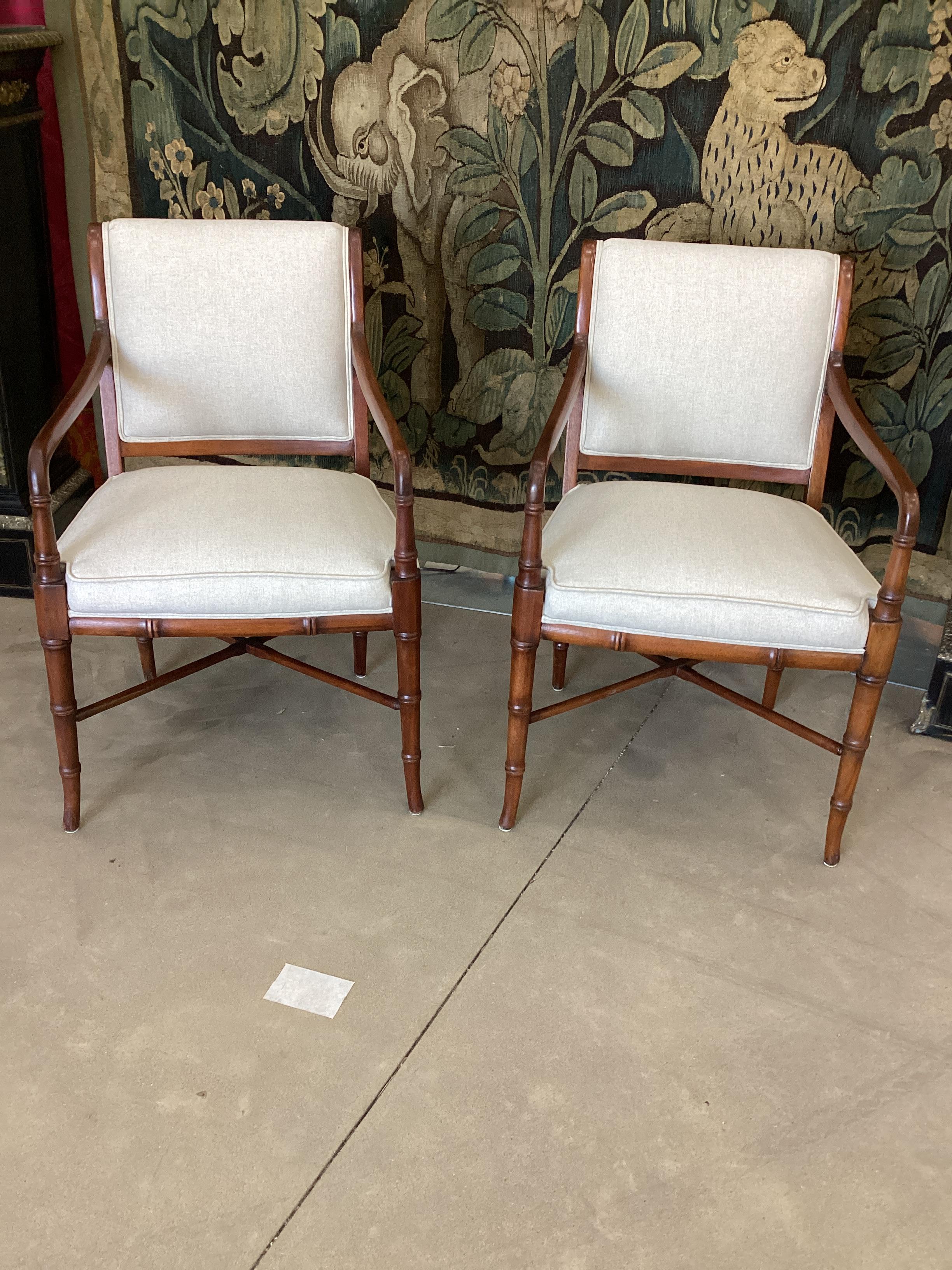 Pair of Faux Bamboo Mahogany Armchairs. Newly upholstered in a light linen fabric. Chairs have been refinished with a new finish in shellac.