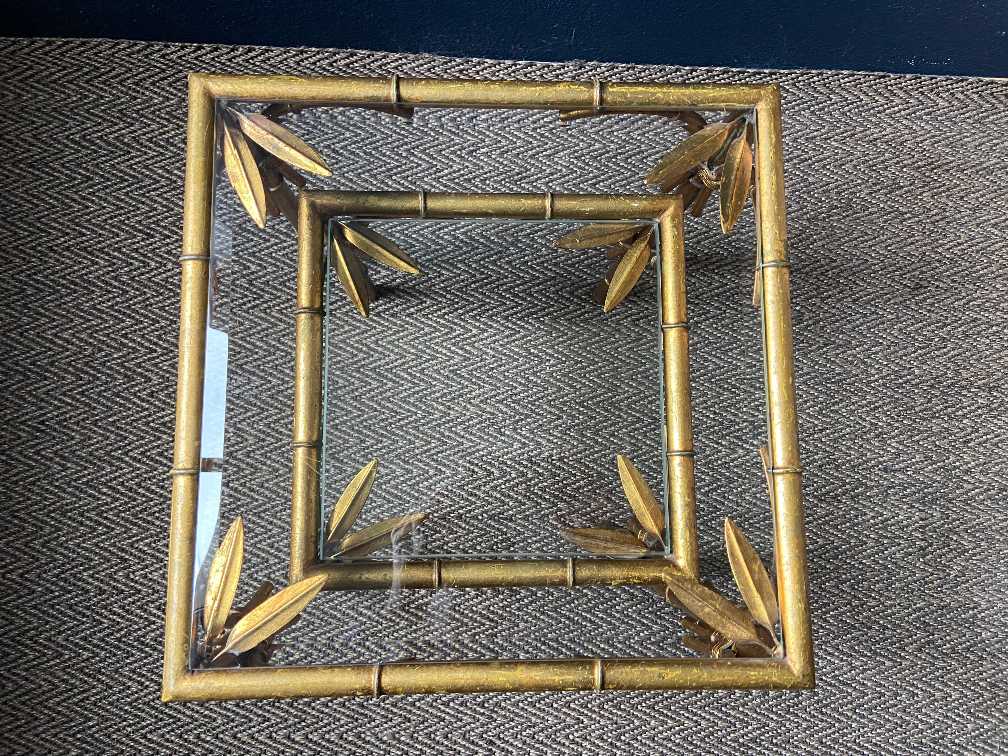 This delightful pair of faux bamboo nesting tables probably hails from 1960's France. 

The elegantly decorated gilt metal frames support square glass tops on each table giving them a light and airy appearance. 

Well proportioned and in good stable