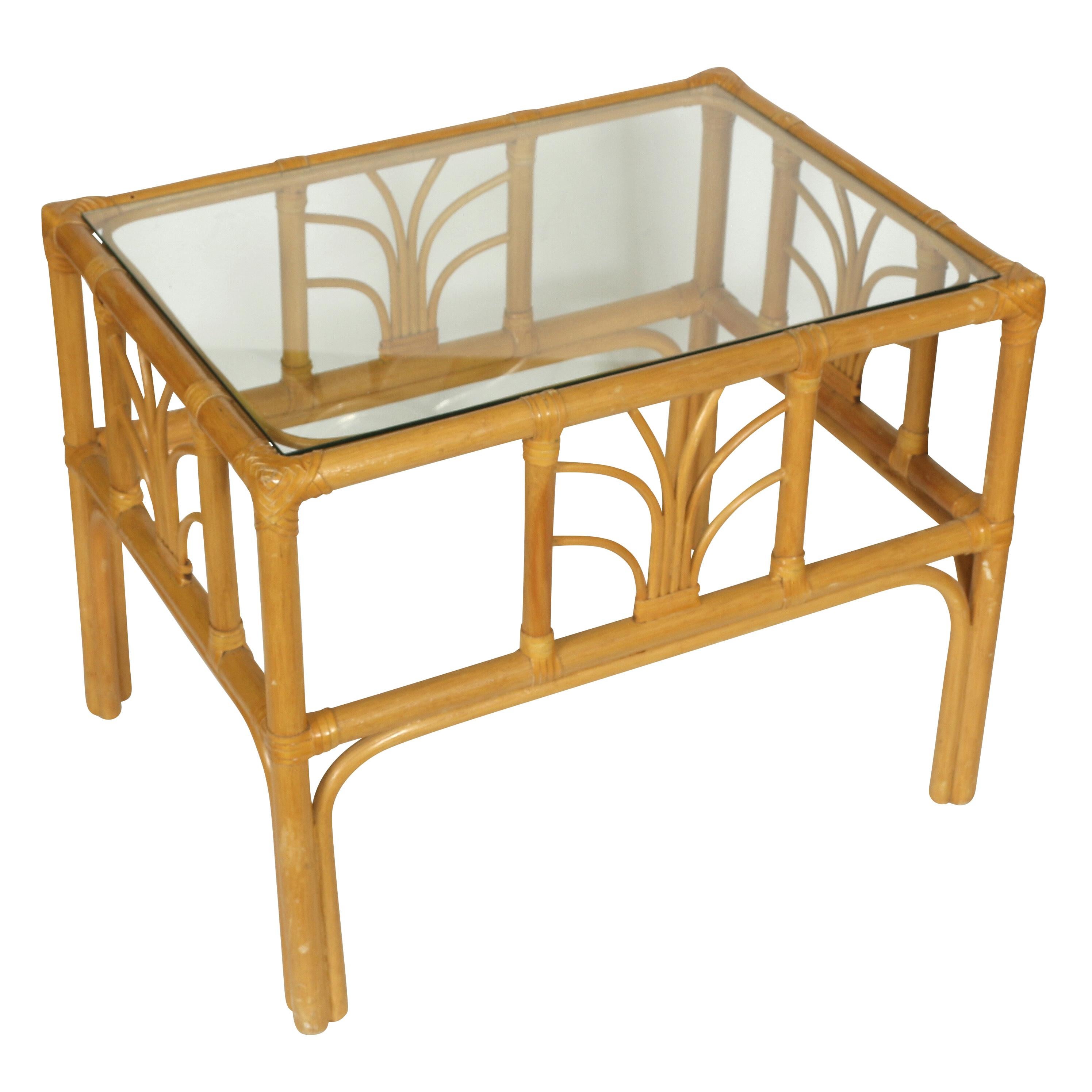 A nice little pair of faux bamboo side tables with a leaf design on each side and a glass top. This duo could serve as bedside tables or flanking a sofa.