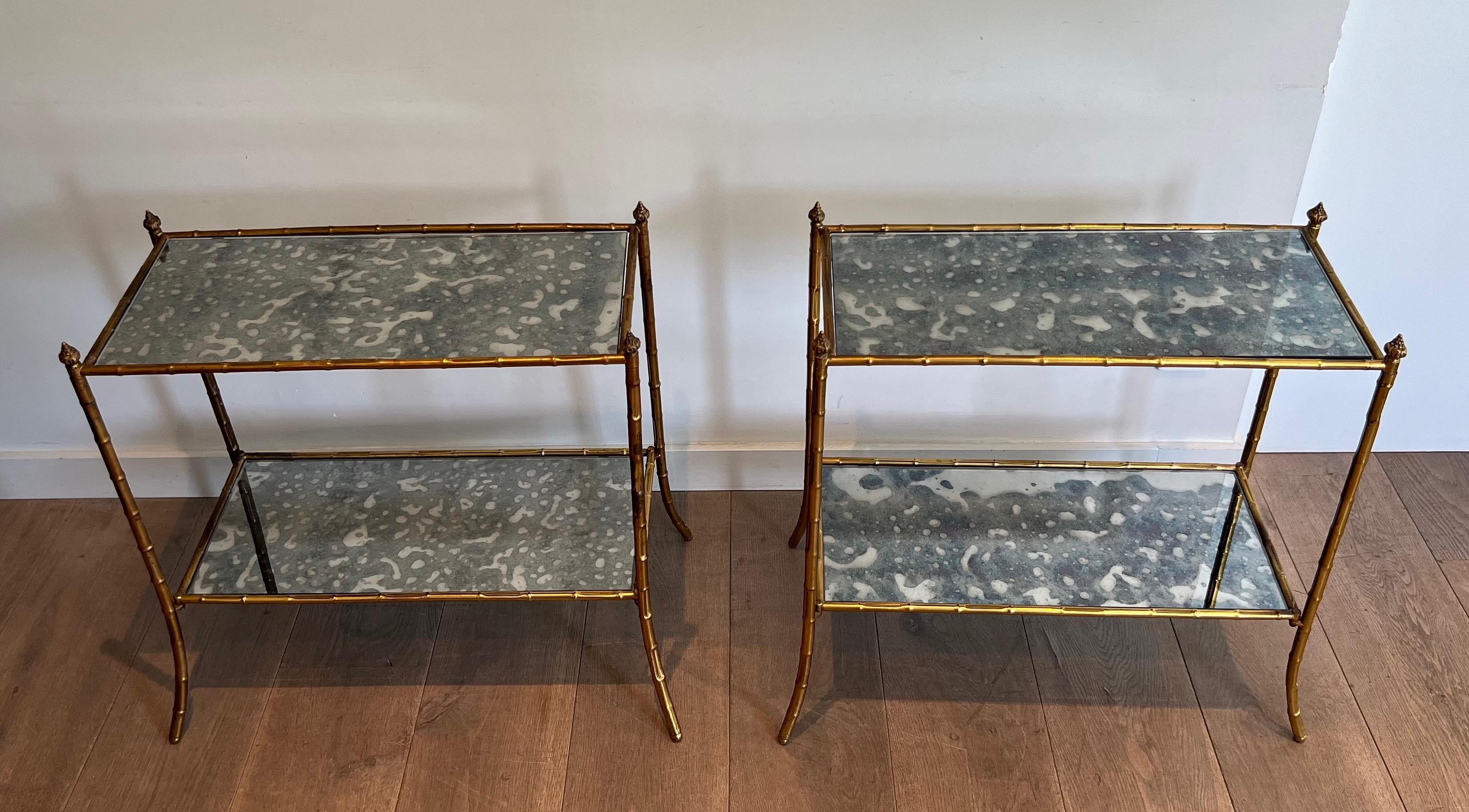 This pair of faux-bamboo side tables is made of gilt metal with beautiful oxydized mirror tops. This is a French work in the Style of Maison Baguès. Circa 1940