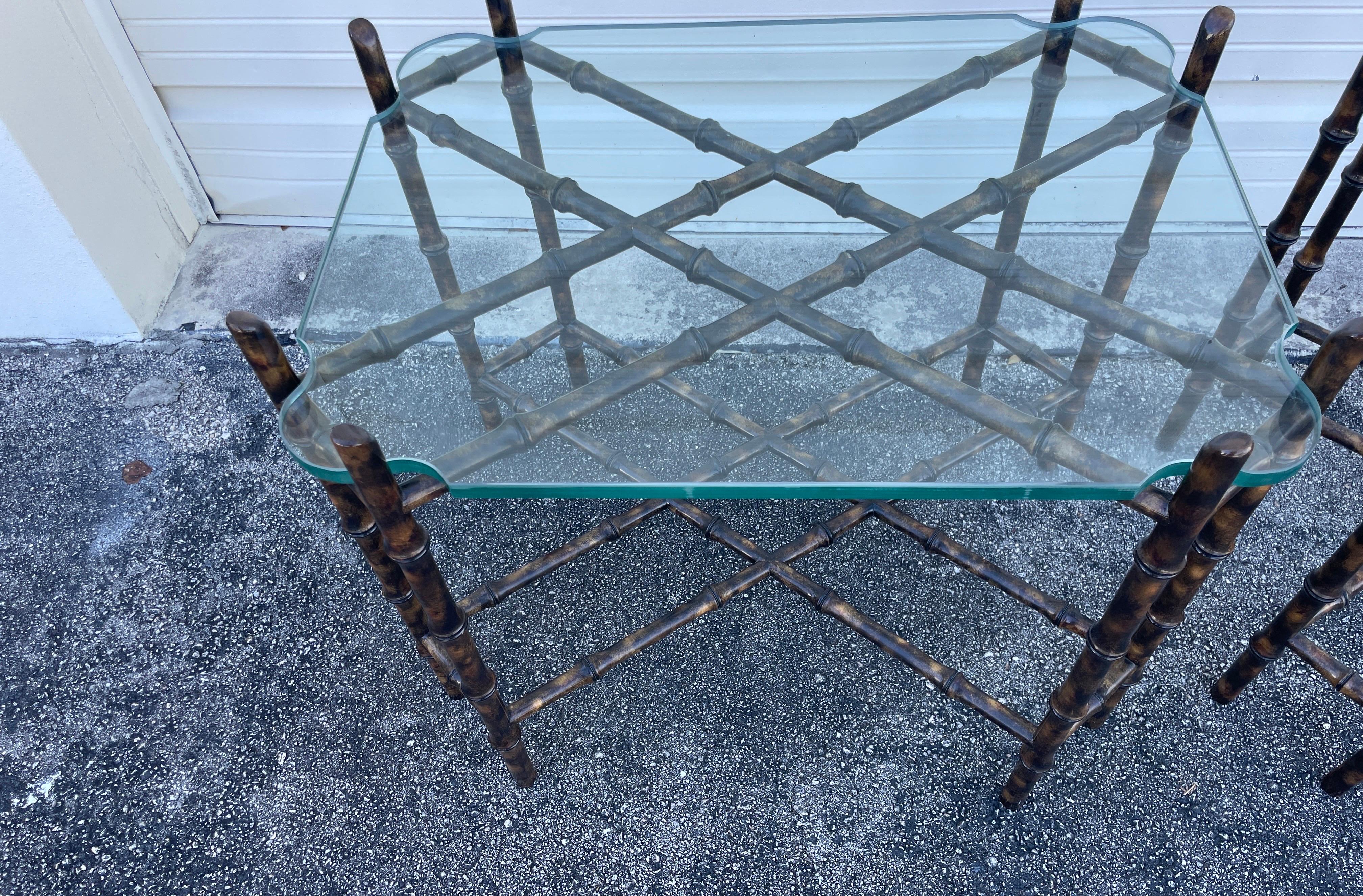 Stunning pair of tortoise finish faux bamboo side tables with glass tops. Very fine condition and quality.