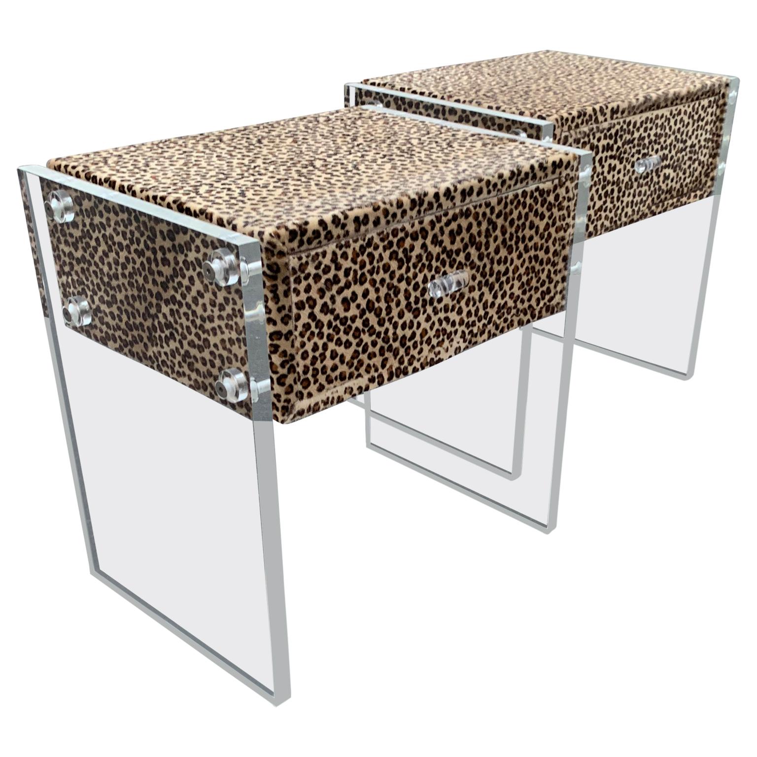 Pair of faux cheetah skin upholstered nightstands with Lucite side panels.