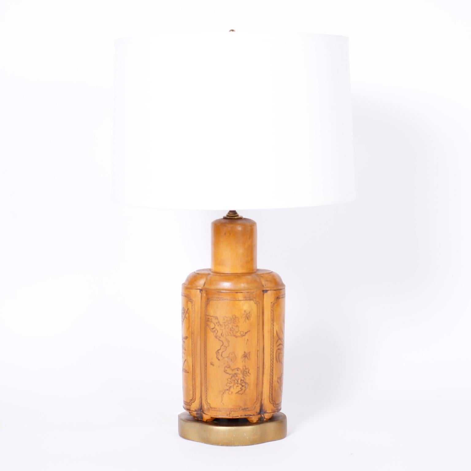 Pair of Asian Modern style table lamps crafted in composite with a Classic tea canister form and featuring a faux tooled worn leather finish presented on burnished brass bases.