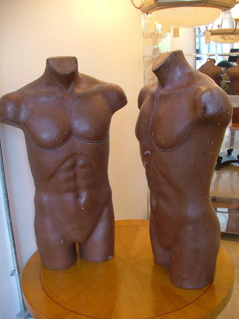 Pair of faux leather male torso mannequins with white stich detail 1940s.