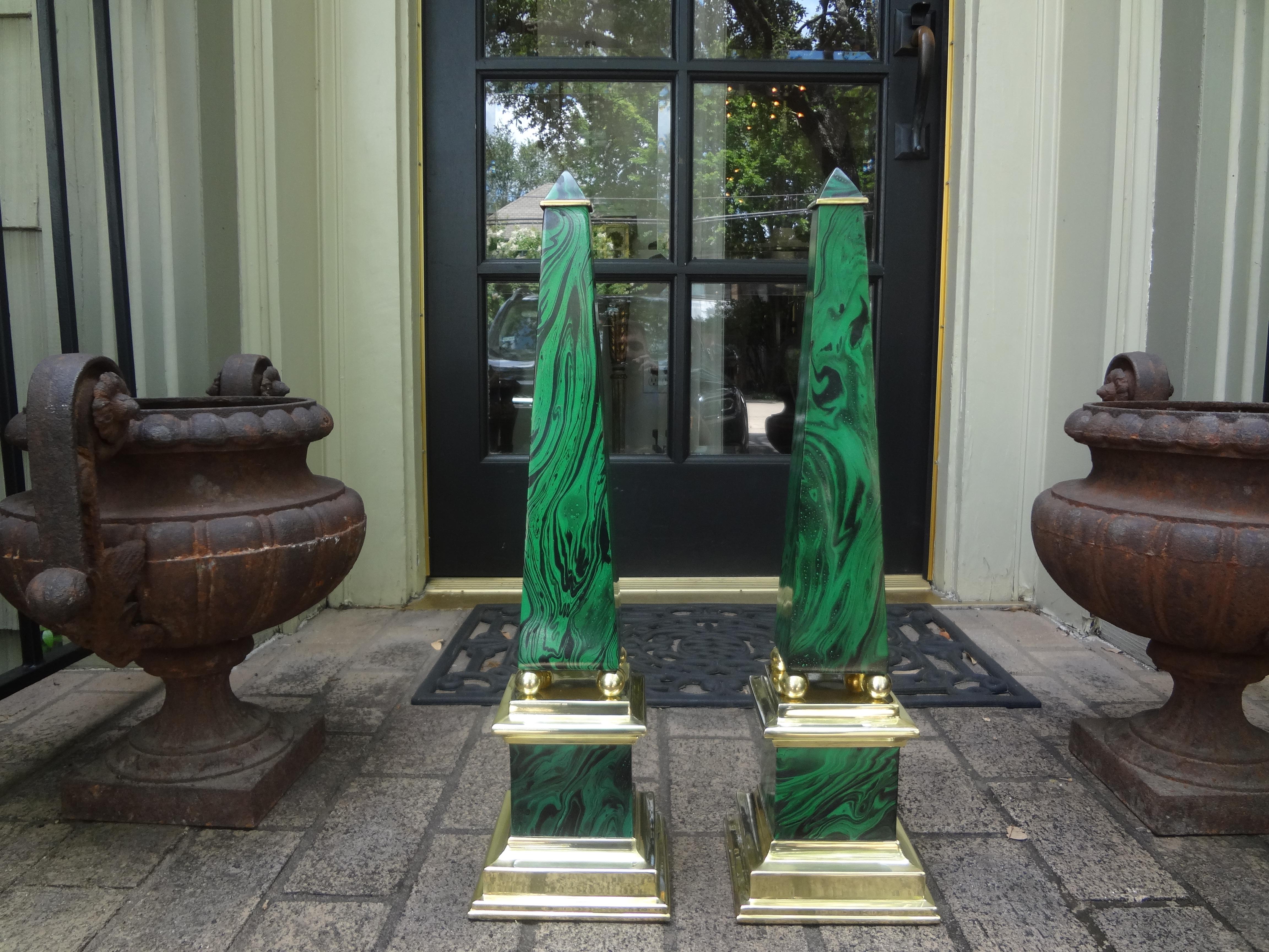 Pair of Faux malachite and brass obelisks.
Fantastic pair of vintage faux malachite and brass obelisks. This beautiful pair of midcentury obelisks are a pair but in the spirit of naturally occurring malachite, they appear a bit different in
