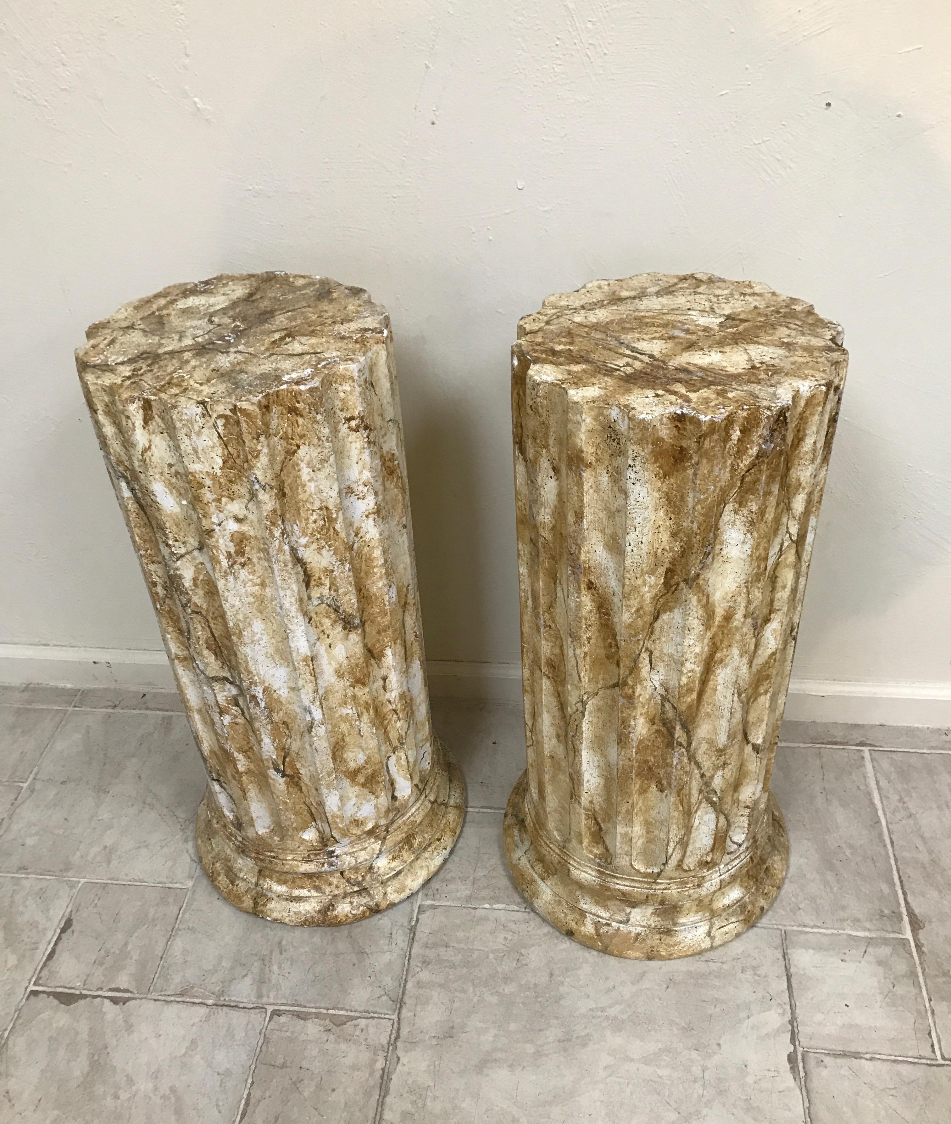 Pair of fluted plaster pedestals painted with a faux marble finish. Pedestals are 29