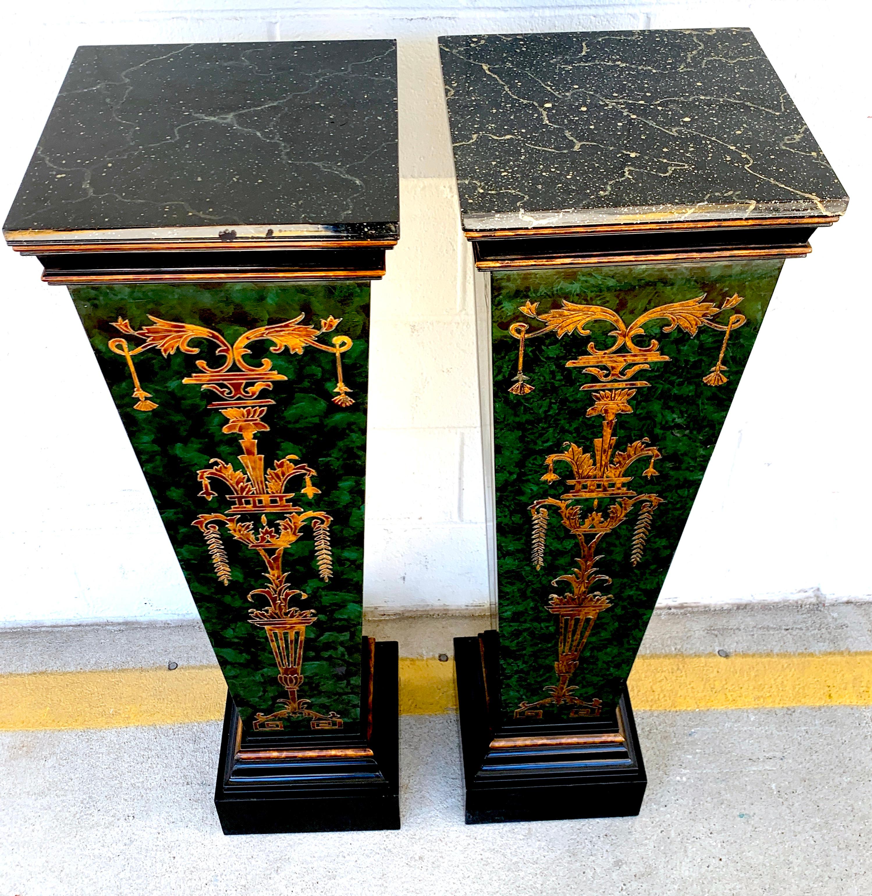 Pair of faux painted green and gilt neoclassical pedestals, each one with a 12-inch square marbleized top, on a tapering pedestal base with all-over incised and gilt decoration.