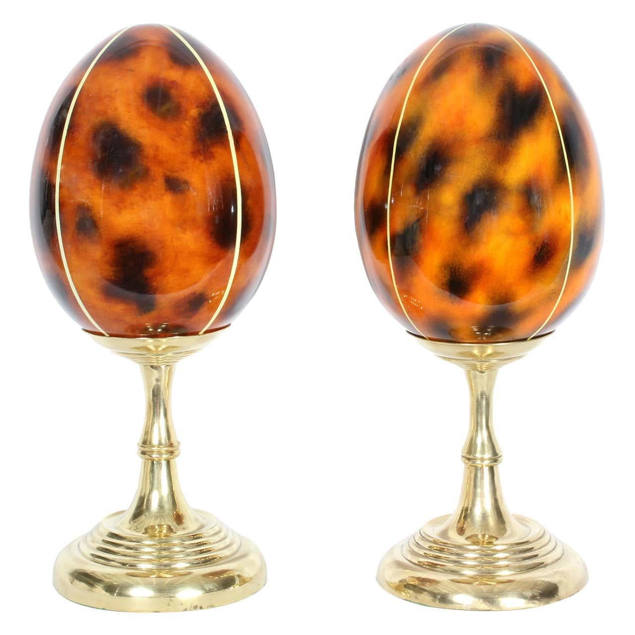 A pair of faux tortoise lacquered egg shaped objects de arte on solid brass turned pedestals, with a candlestick vibe. No home is complete without them.
Possibly by Maitland - Smith. Newly polished.

 