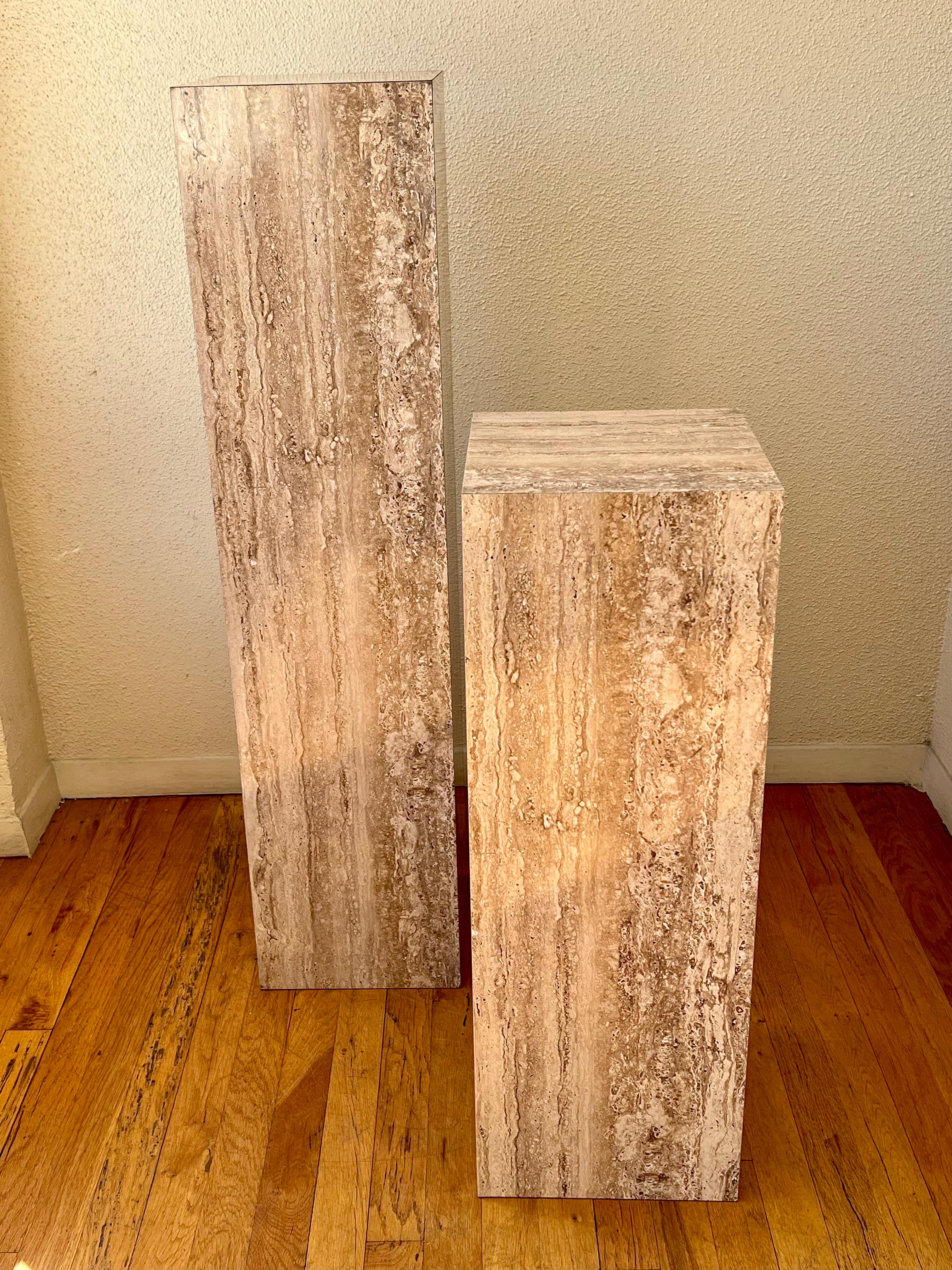Versatile pair of pedestal columns in faux travertine laminate, excellent condition circa 1980's one taller and one shorter great for display sculptures, easy to move lightweight. Measures: The tall one is 10