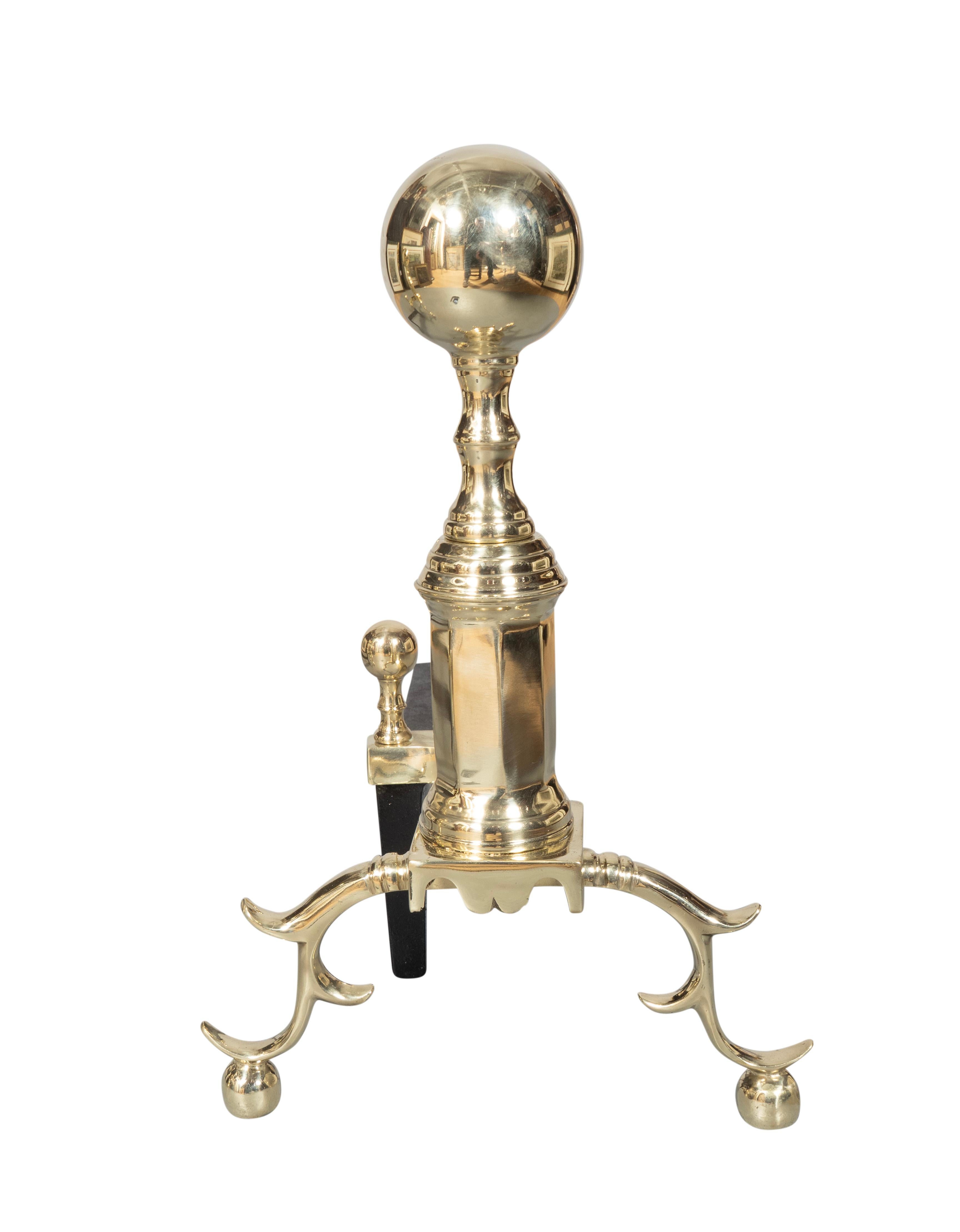 Ball top with cylindrical support. Curved legs and ball feet. Fire dogs with brass ball finials. Newly polished.
