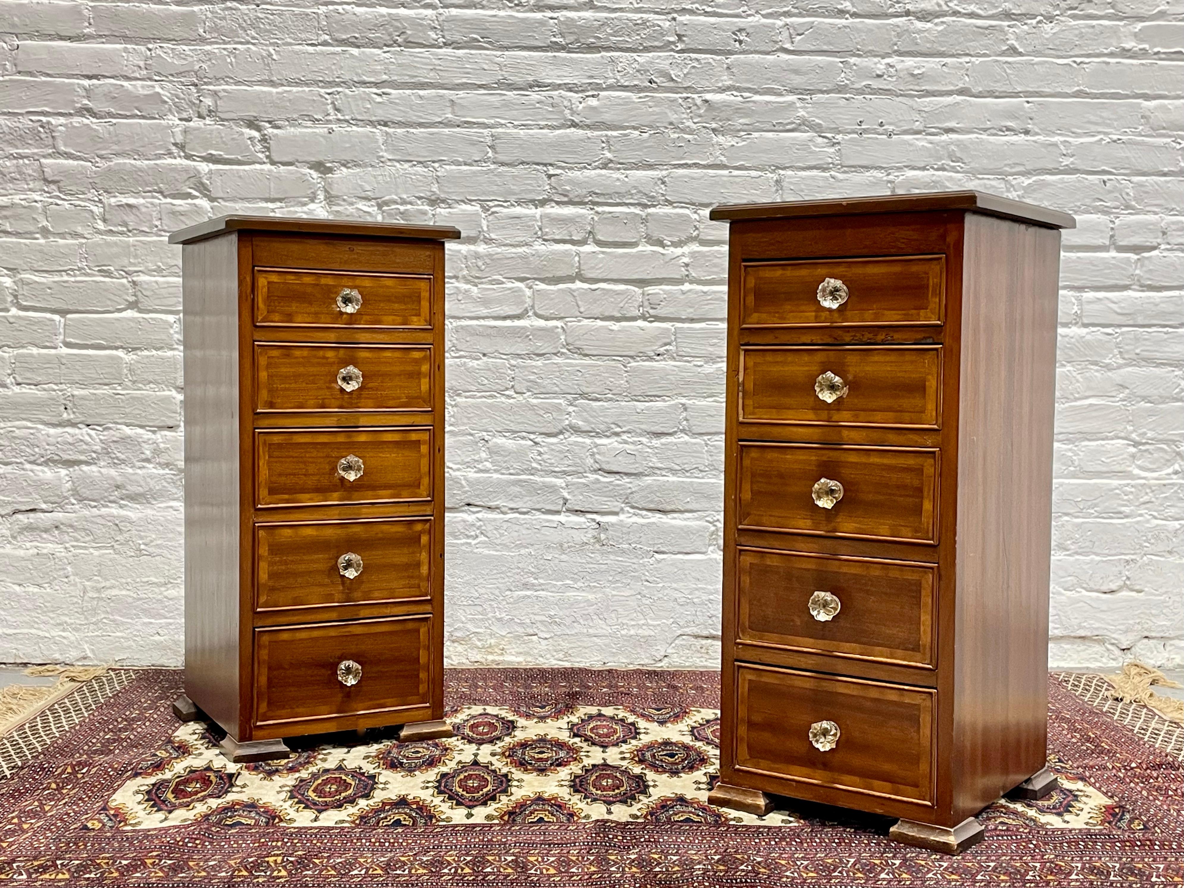 Pair of Early 20th Century Federal Style Mahogany Cabinets.  Each stand has five dovetailed drawers with glass flower shaped knobs. These would be perfect as nightstands, lingerie cabinets or storage for crafts. Beautifully crafted with lovely