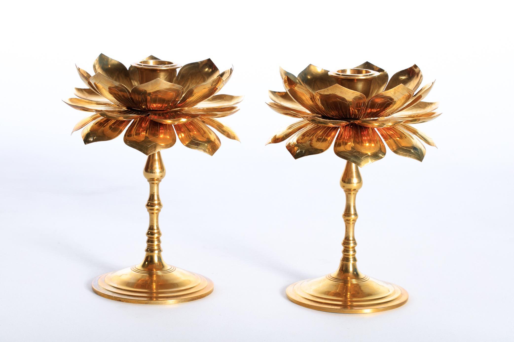 Rare and beautiful pair of lotus flower candlesticks by Feldman in the style of Parzinger. The beautifully polished brass finish reflects the gentle glow of the candle light making these delicate, elegant and most noticeable. An additional feature -