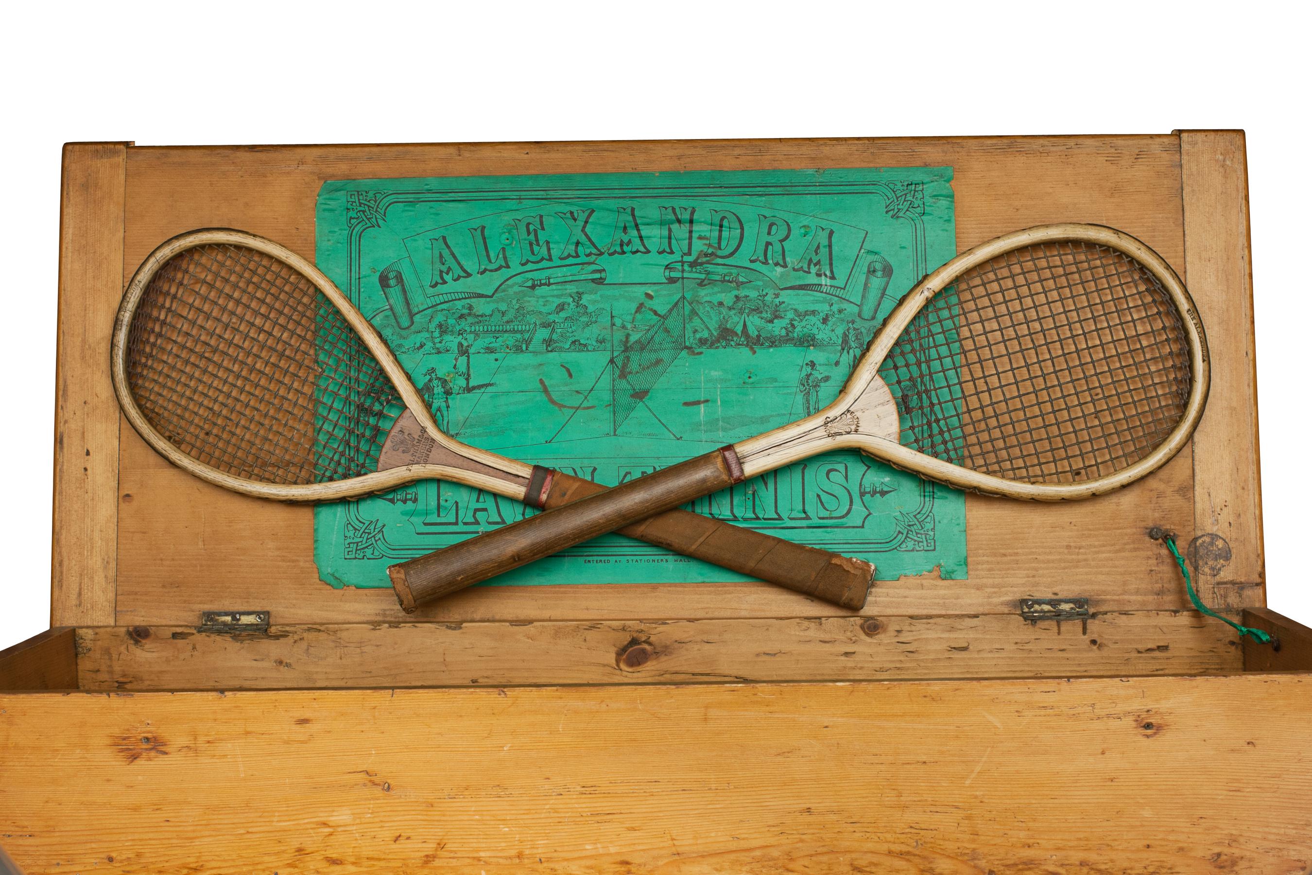 The Alexandra Lawn Tennis Set.
A rare pair of early lawn tennis rackets in good original condition by Feltham of London, both stamped on the top 'The Alexandra'. The rackets come in a pine ' Alexandra' lawn tennis box with original green paper