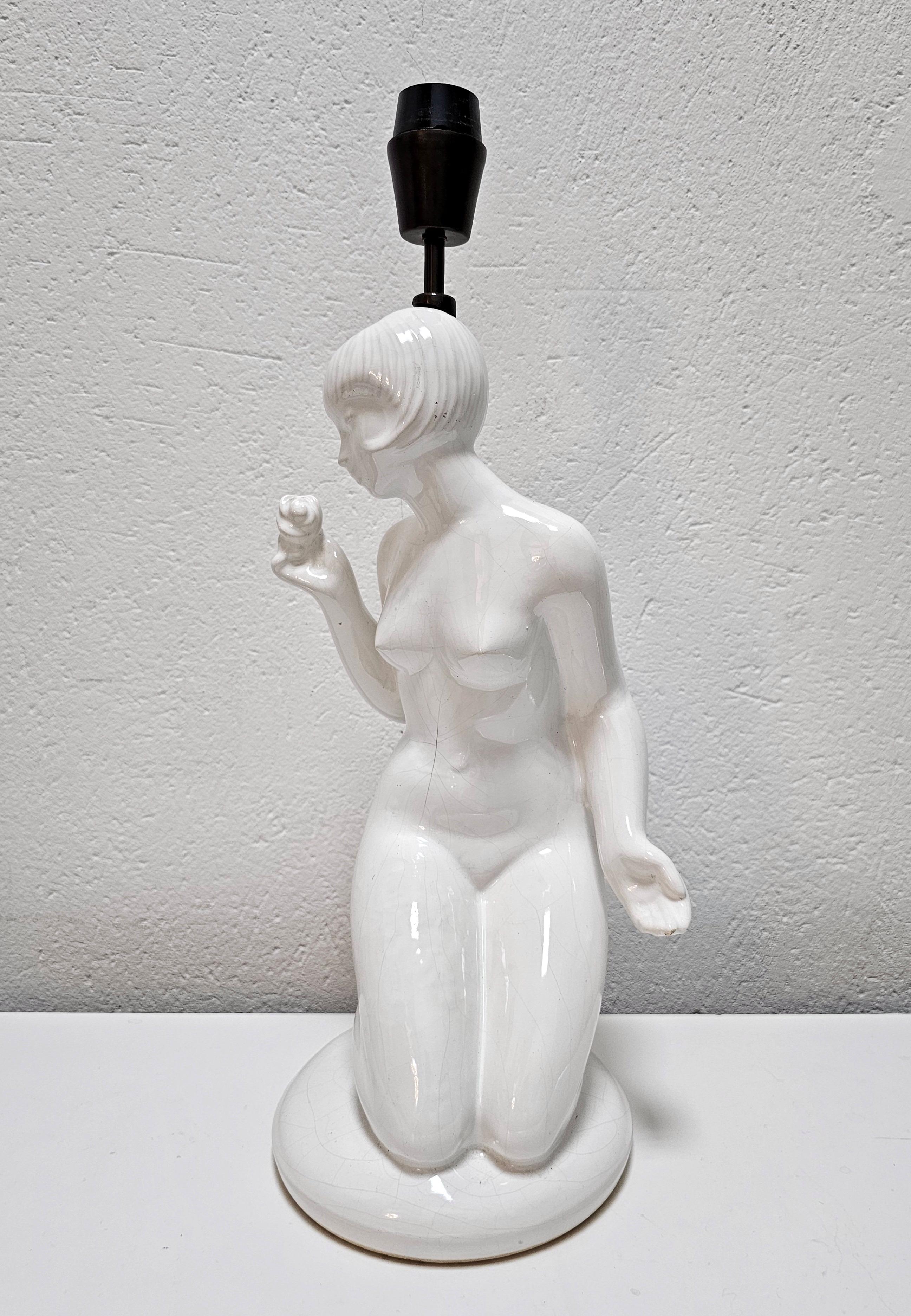 In this listing you will find a pair of white ceramic table lamps, shaped as female nudes with iconic Art Deco haircuts. Model 