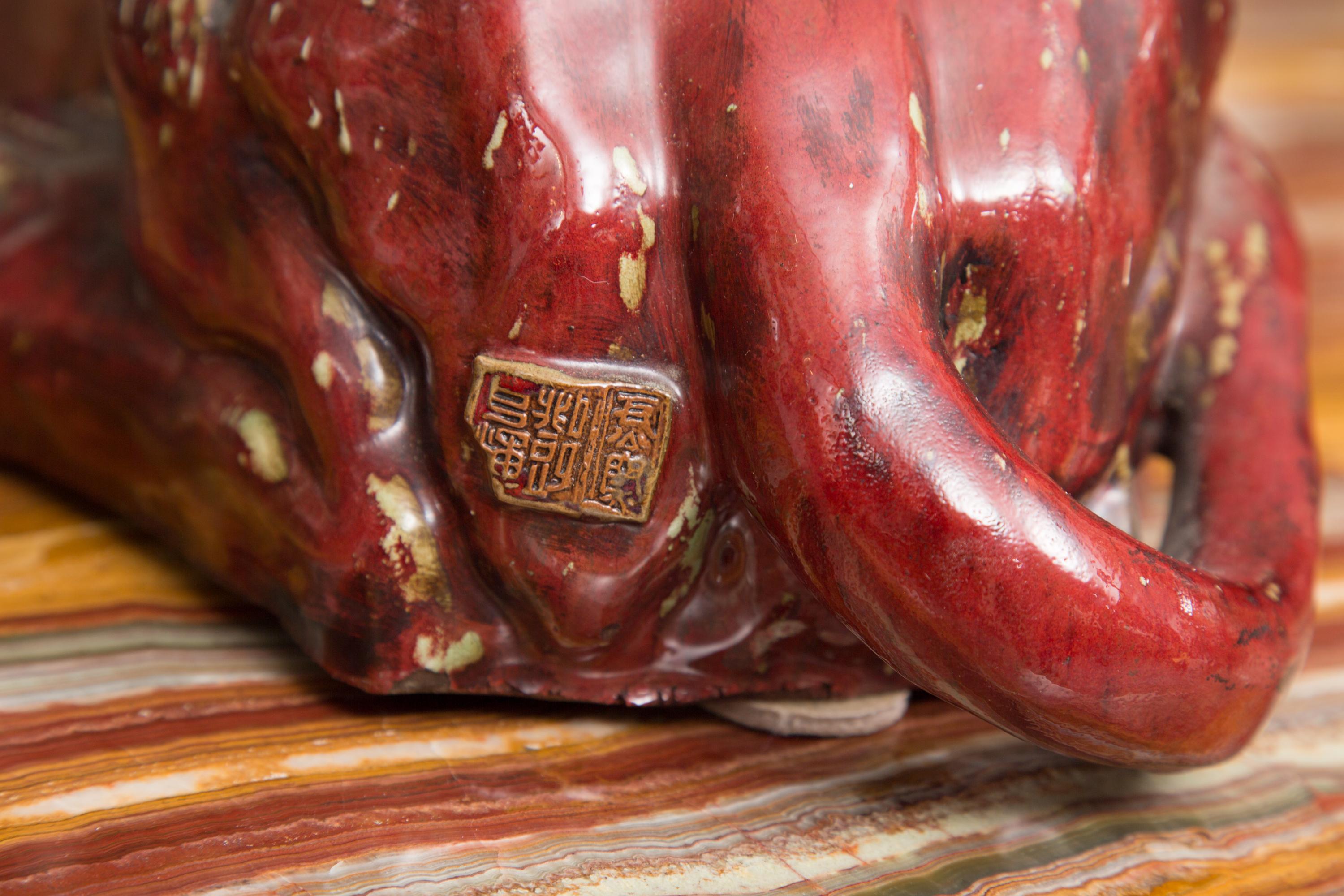 These are an attractive pair of red reclining lions that are heavily glazed with a fiancé covering.