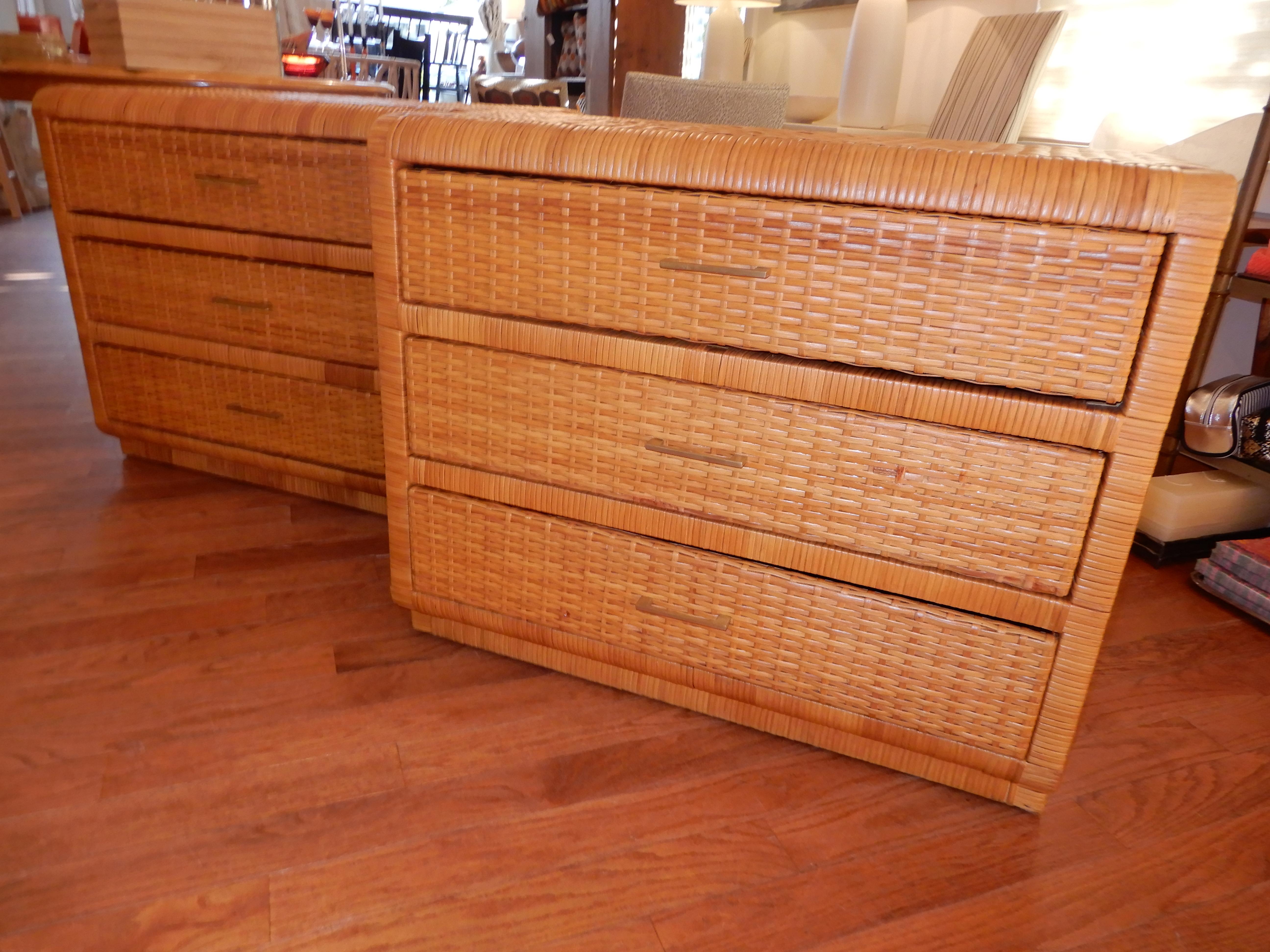 Pair of Fick's & Reed woven rattan three drawer chests or dressers, with original brass pulls, nice rounded features at corners, variation between bottom drawer and base giving a platform appearance, immaculate condition, dated around 1970s.U.S.A.