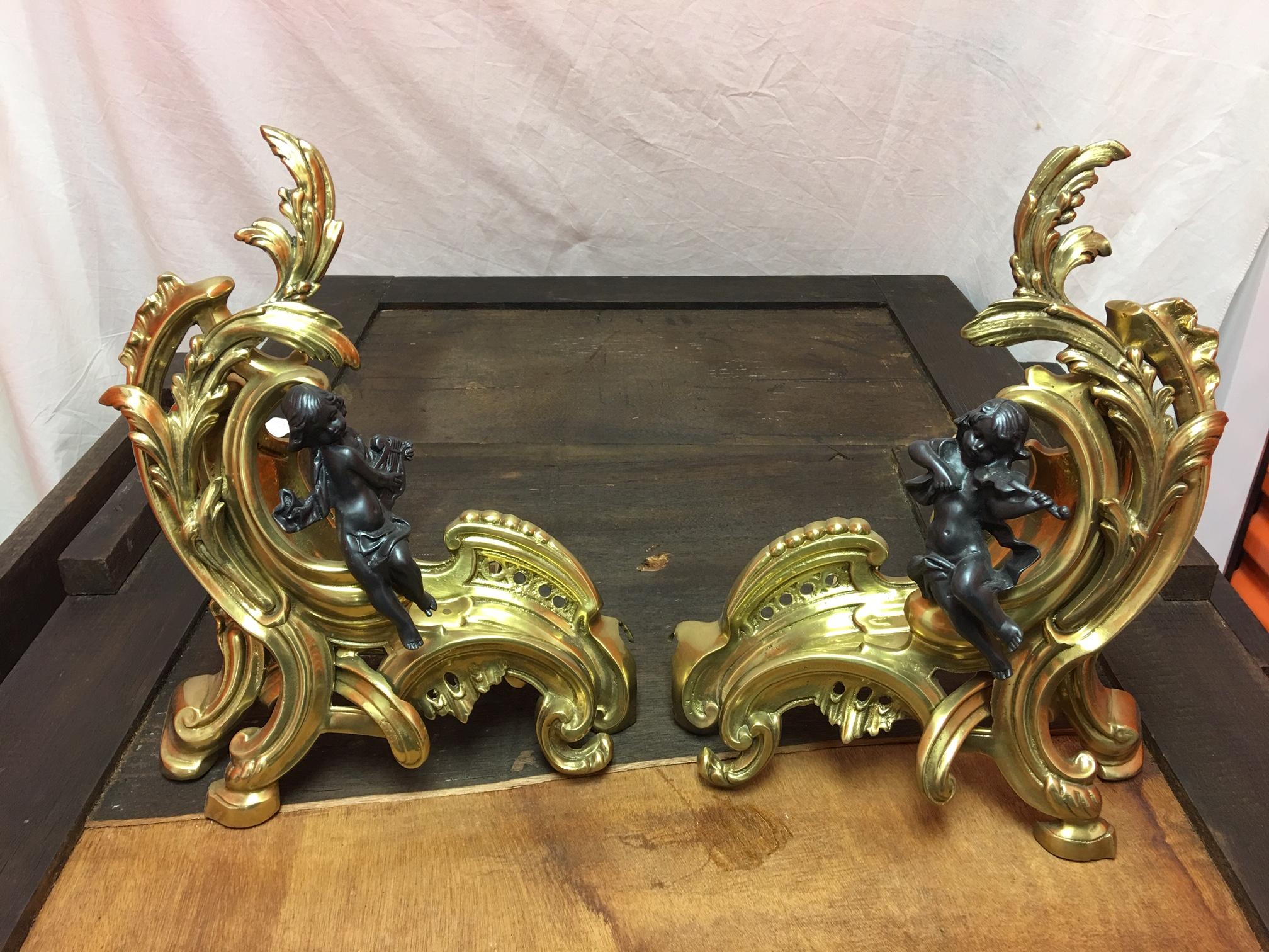 Pair of figural bronze Chenets with a fender, early 20th century.